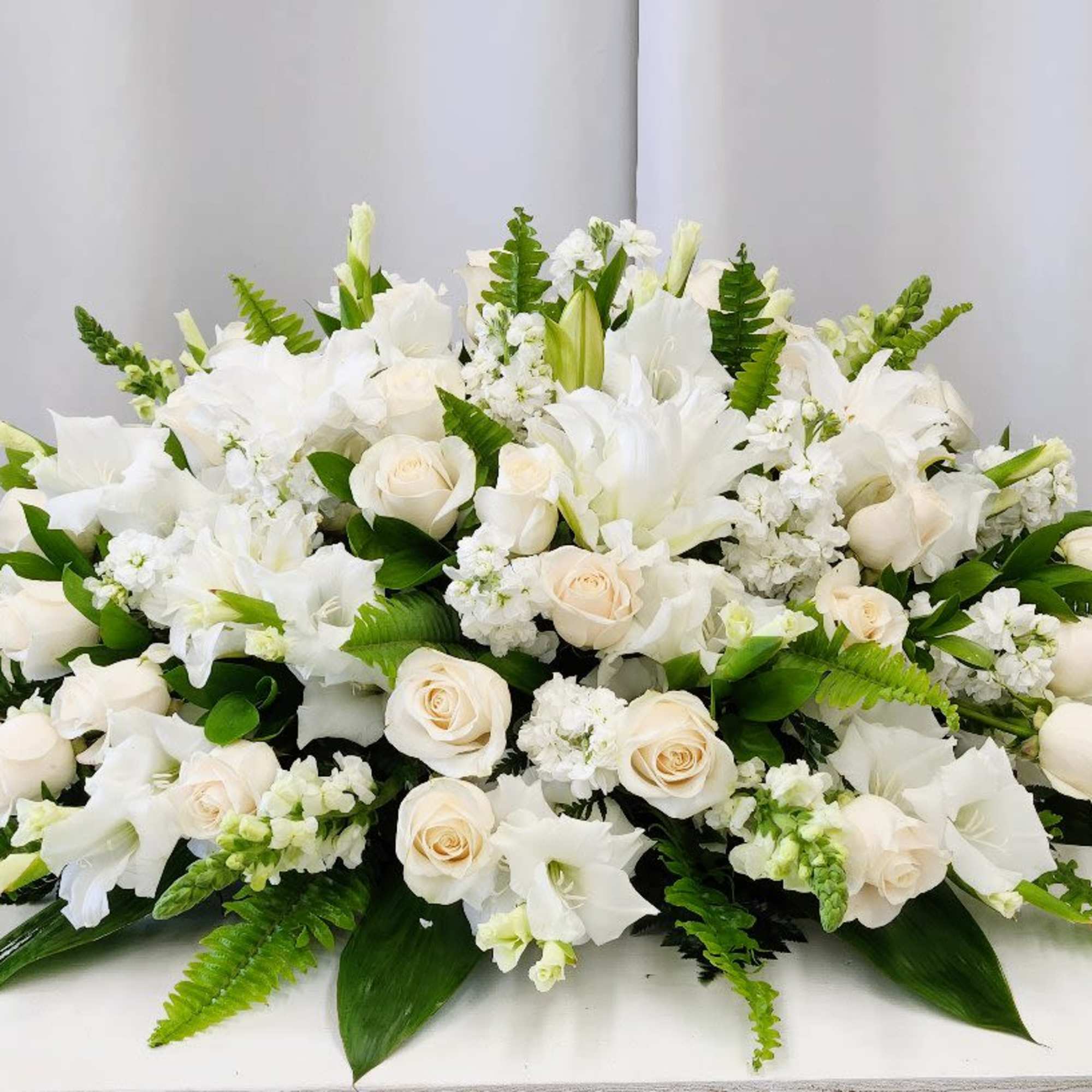 The Heaven Sent Casket Spray offers an elegant and luxurious tribute that