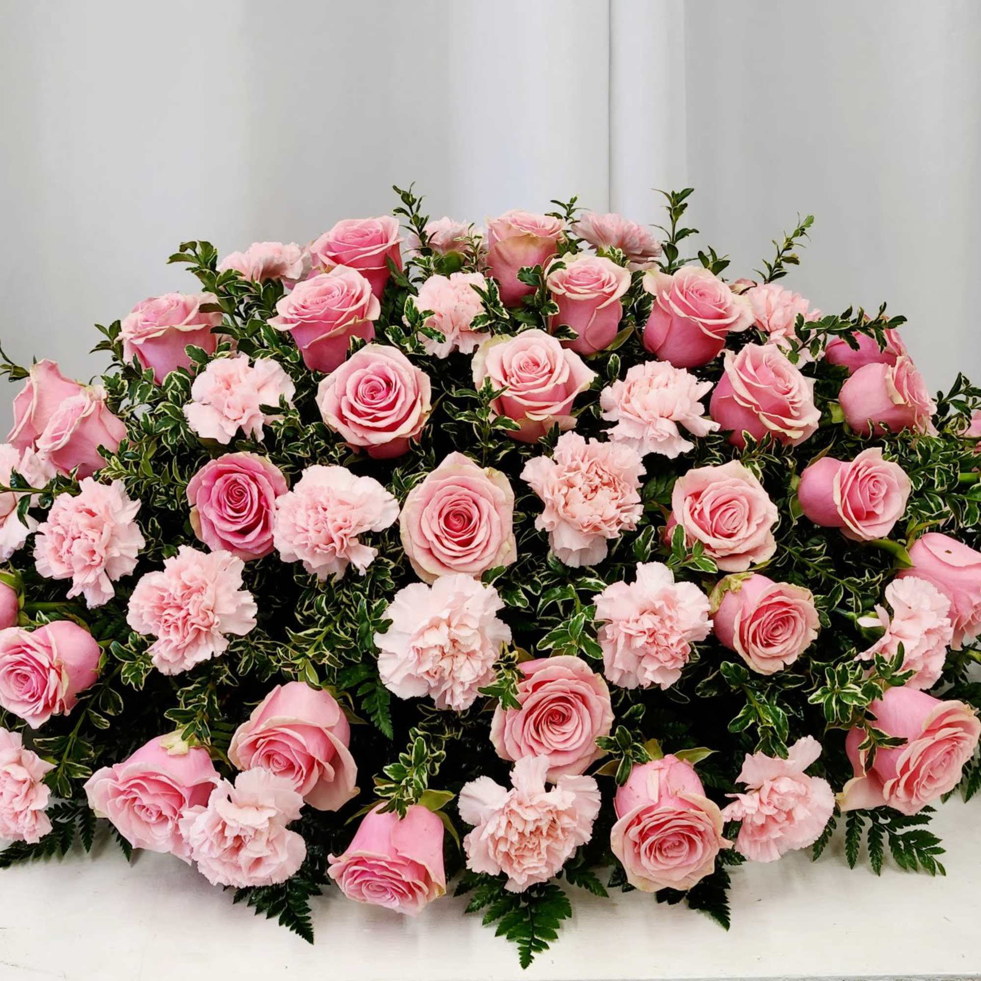 The Gentle Moment Casket Spray offers a soft, pastel-themed tribute that expresses