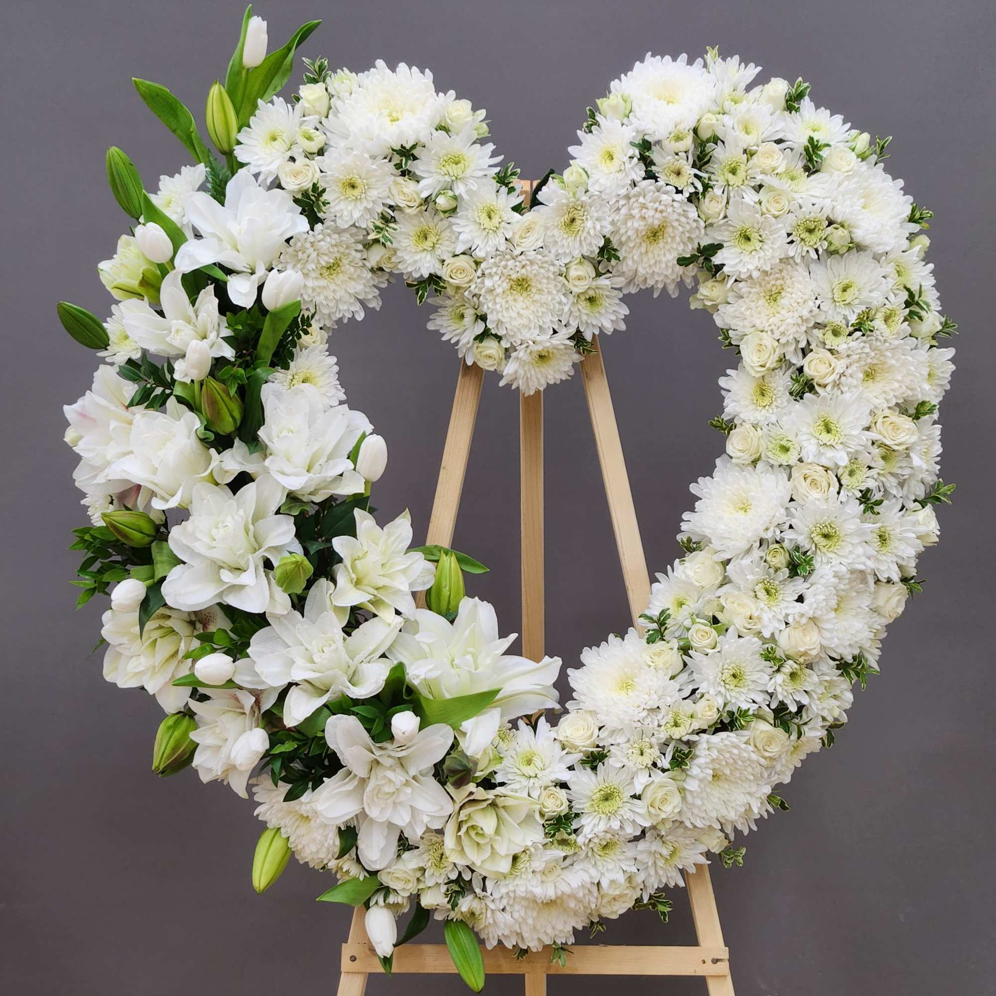 A timeless tribute of pristine white blooms arranged in a graceful heart