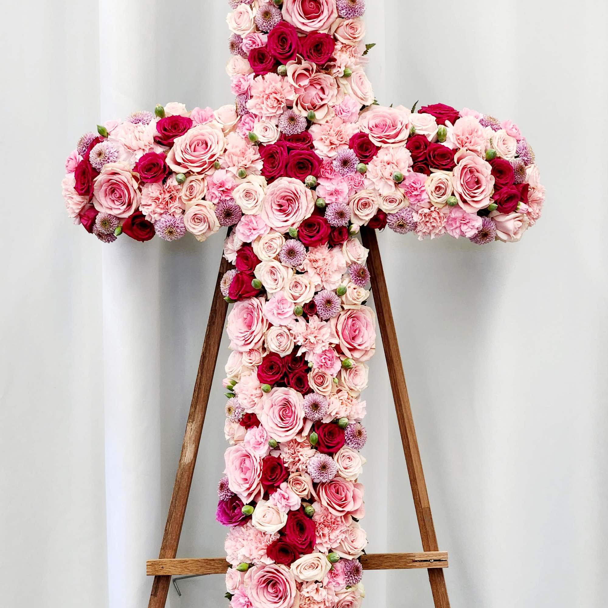 A graceful expression of love and remembrance, this Pink Tribute Cross honors