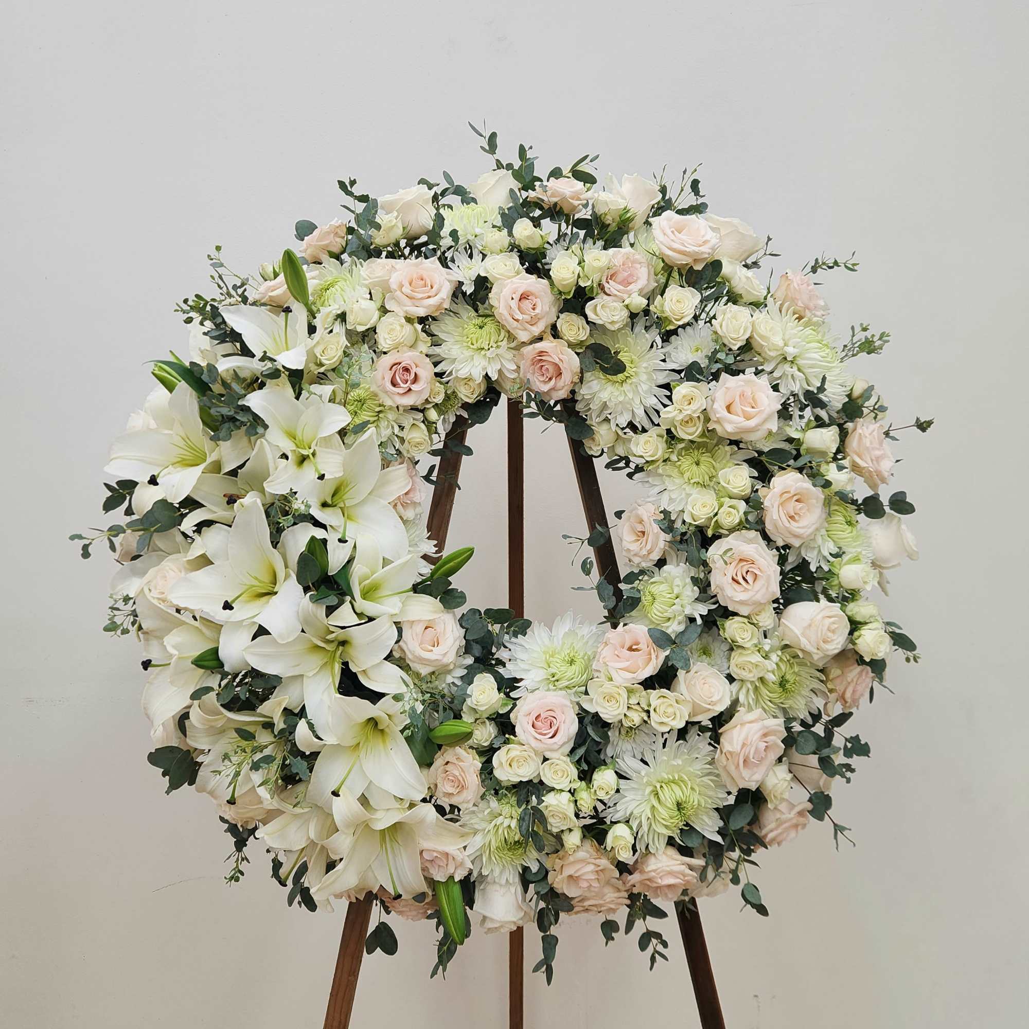 Honor a cherished memory with this elegant memorial wreath. Pristine white roses