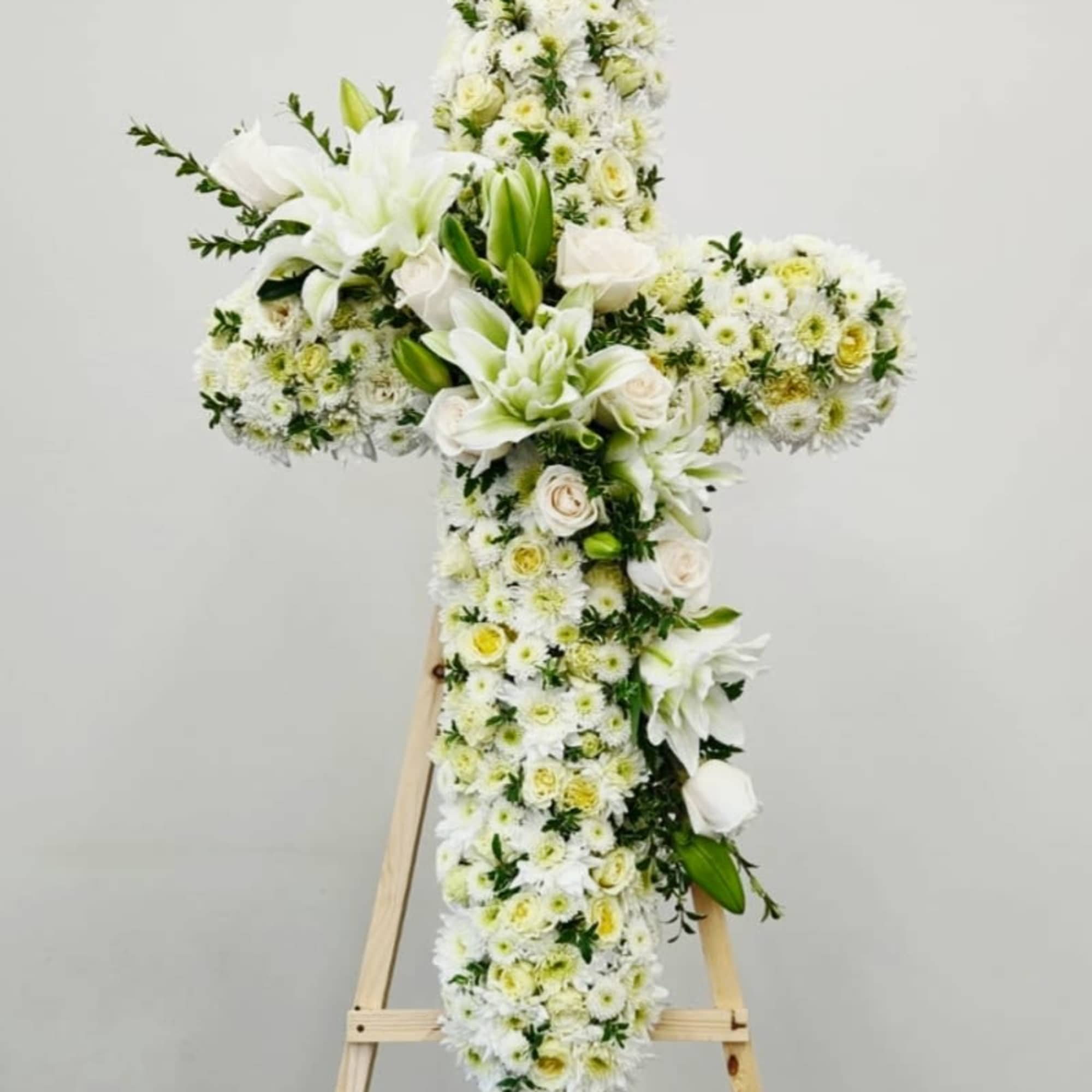 Love and Devotion Cross features an elegant arrangement of white blooms&mdash;roses, mums