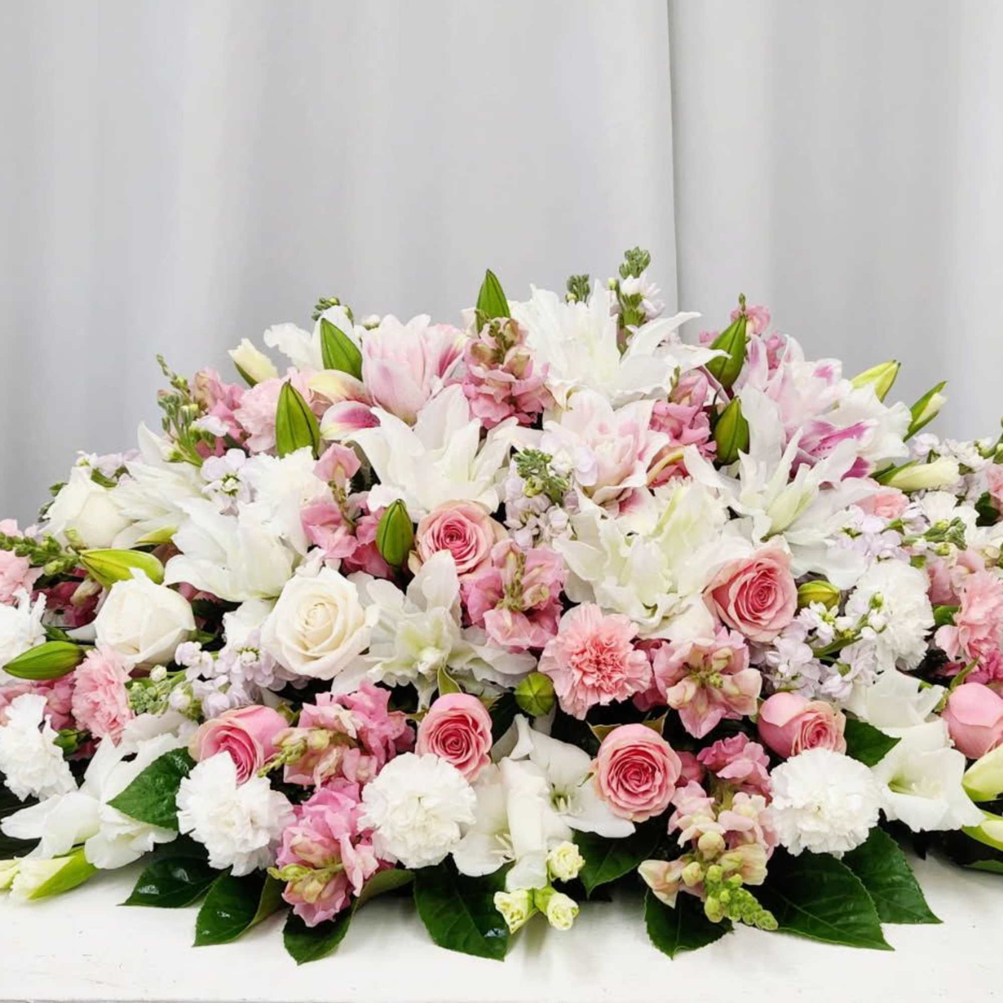 Shipping calculated at checkout.
The Gentle Soul Casket Spray honors a beautiful, kind