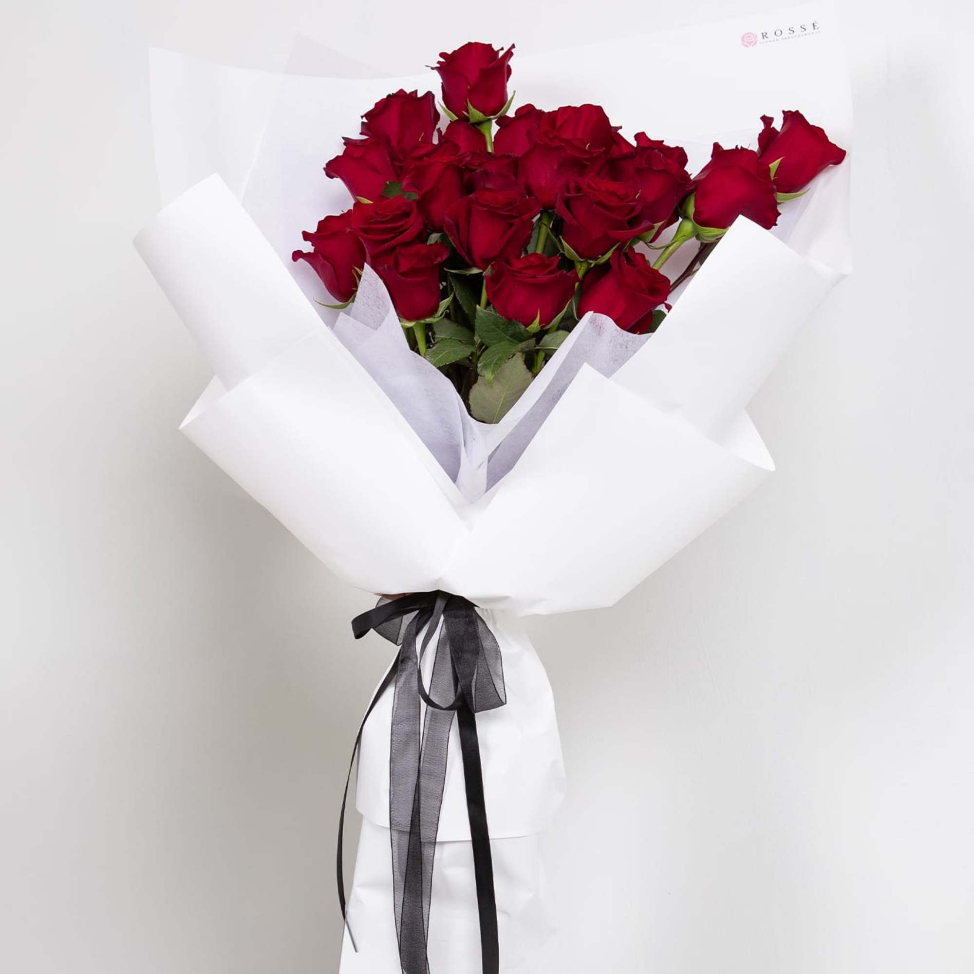 A classic bouquet of two dozen premium roses, softy wrapped for a
