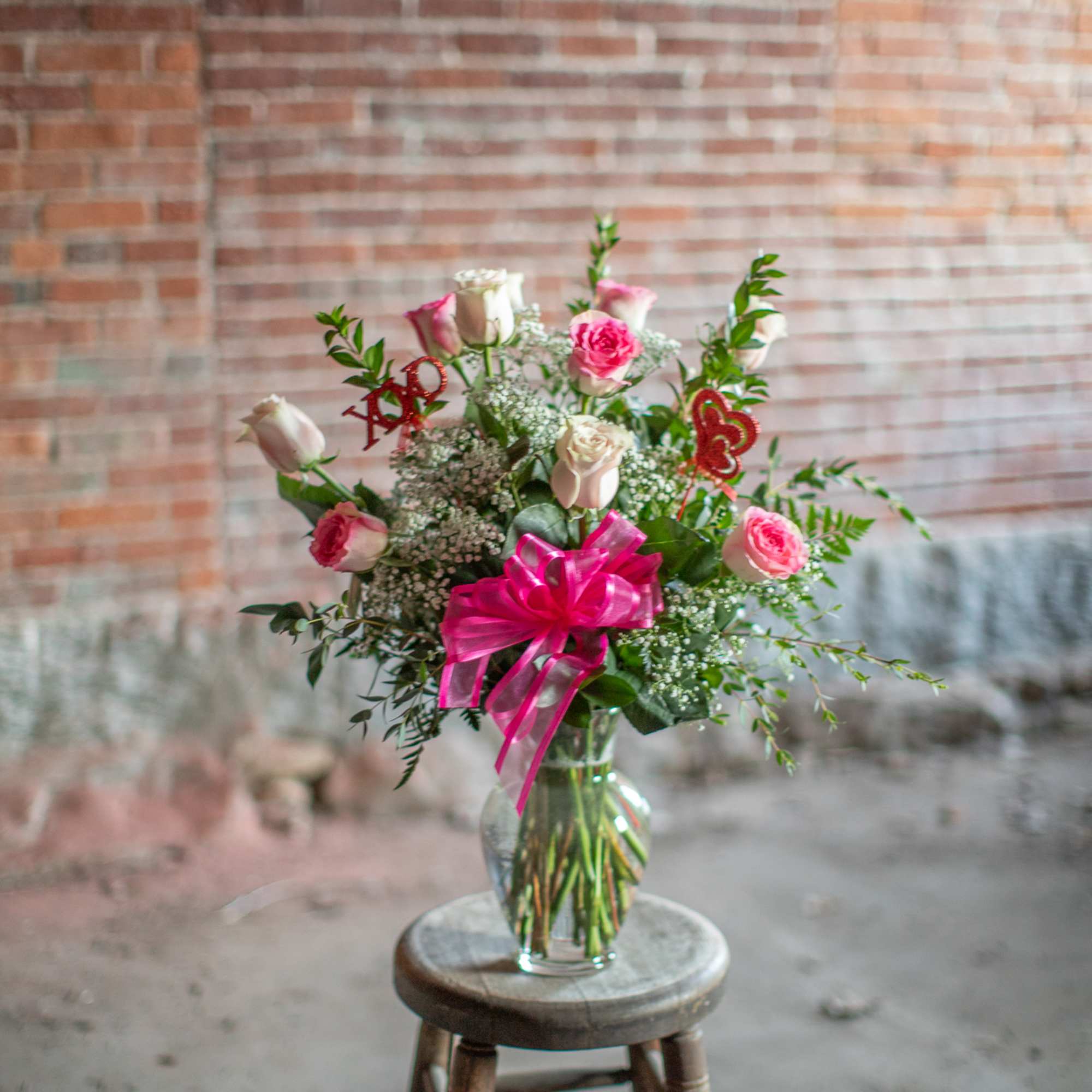 Pretty, premium long stem pink roses are arranged in an all around