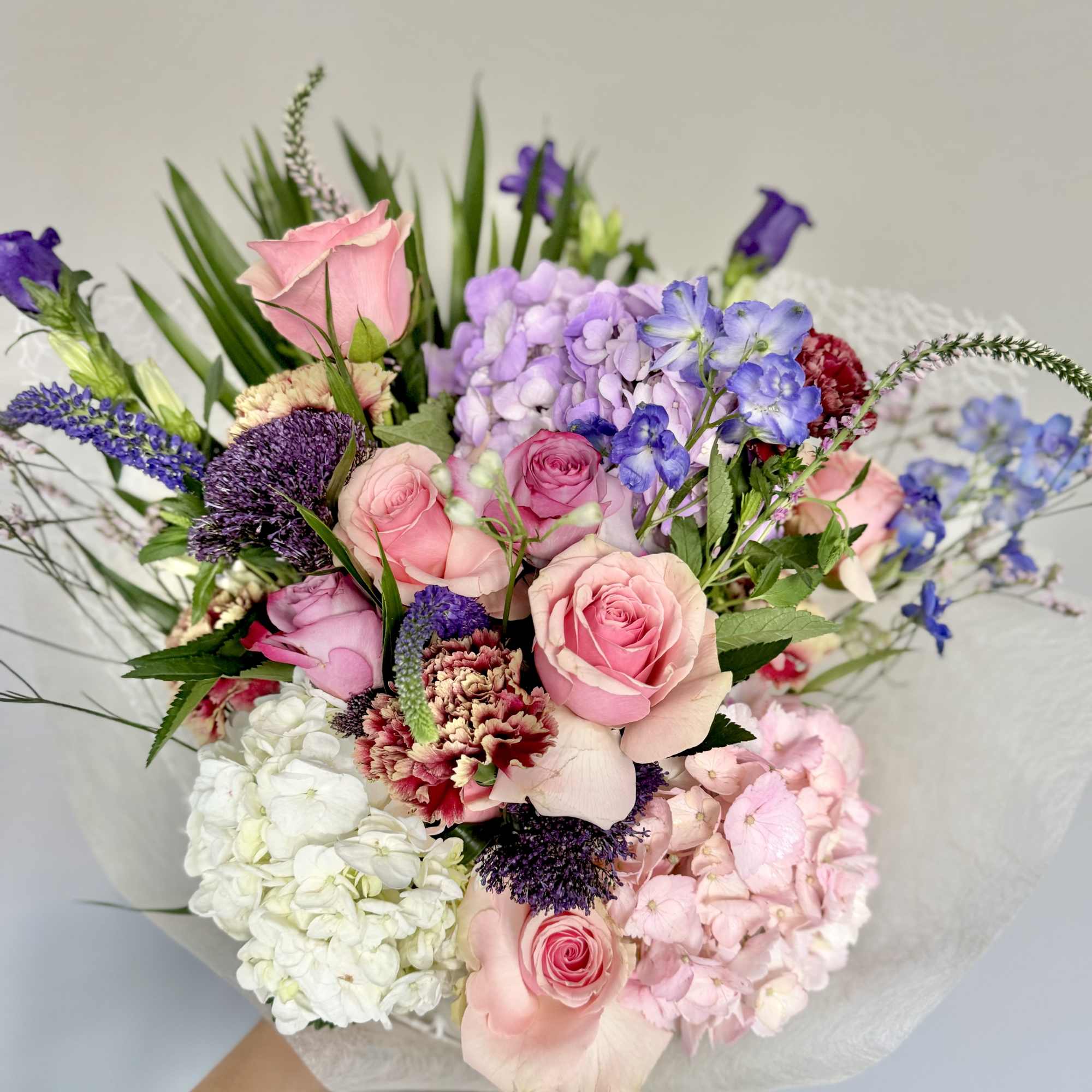 A one-of-a-kind arrangement designed with the freshest seasonal blooms, thoughtfully crafted to