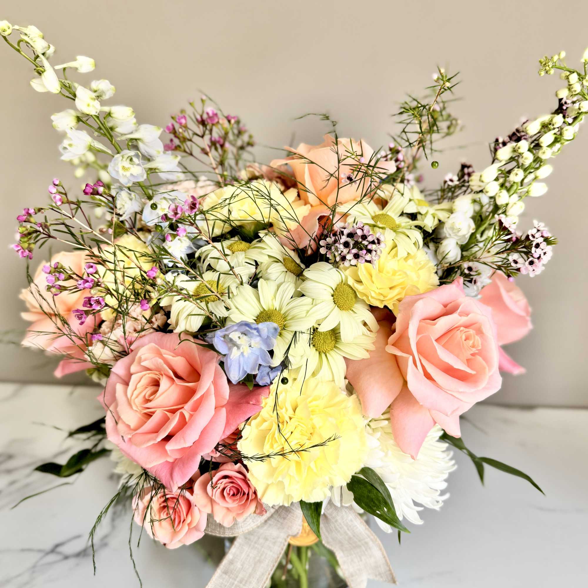 A one-of-a-kind arrangement designed with the freshest seasonal blooms, thoughtfully crafted to