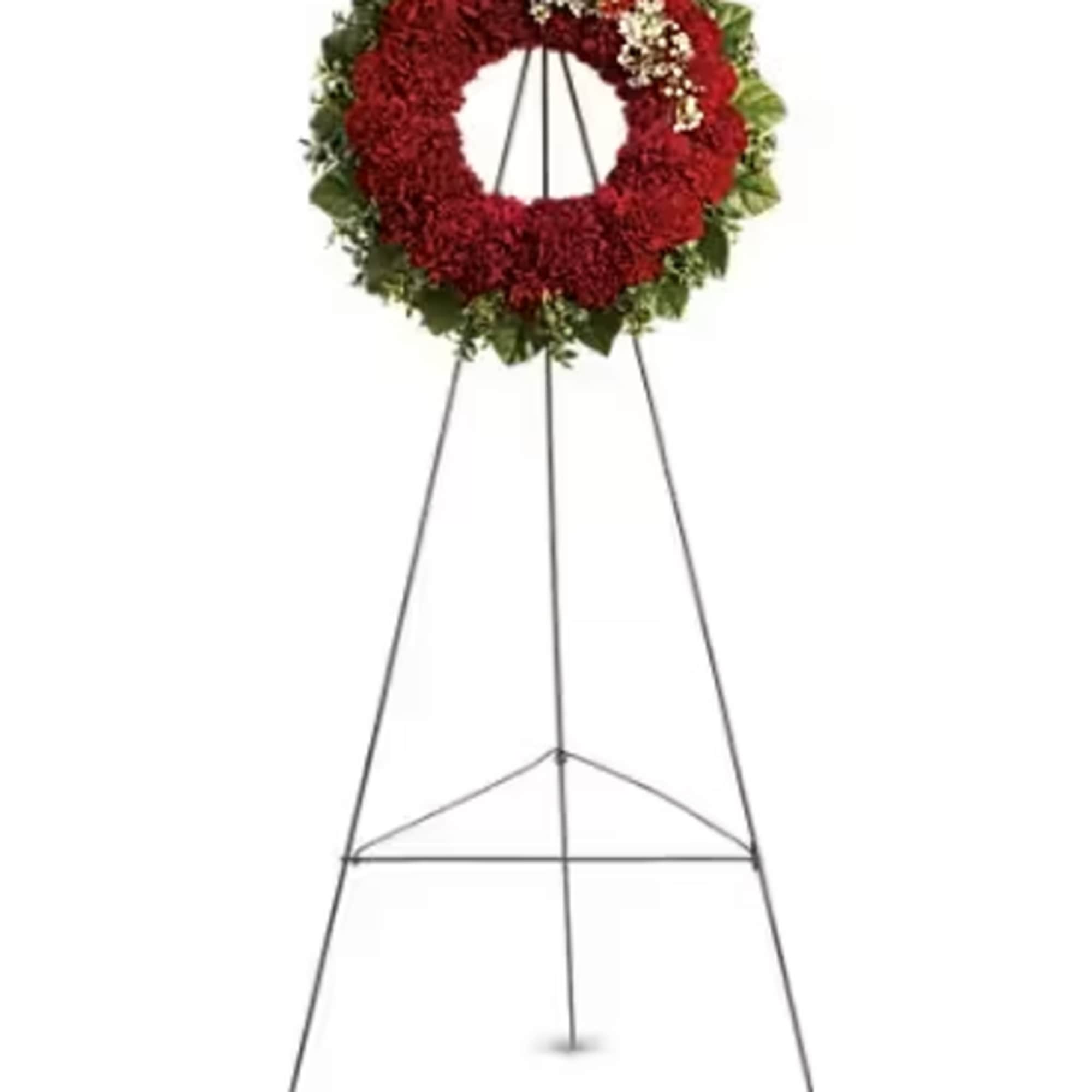 The dazzling red carnations that make up this respectful wreath signify your