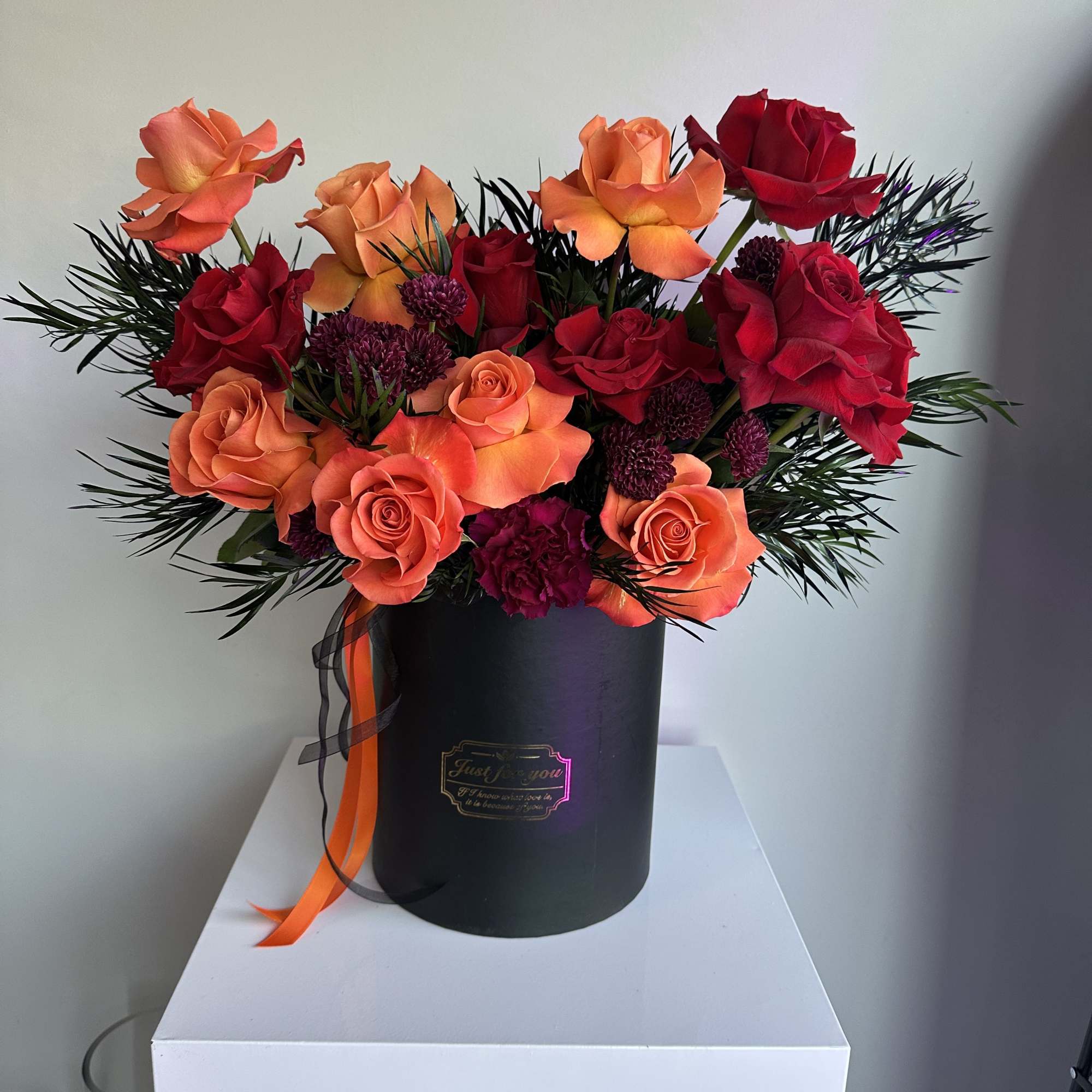 Ignite any occasion with this bold and luxurious arrangement featuring vibrant orange