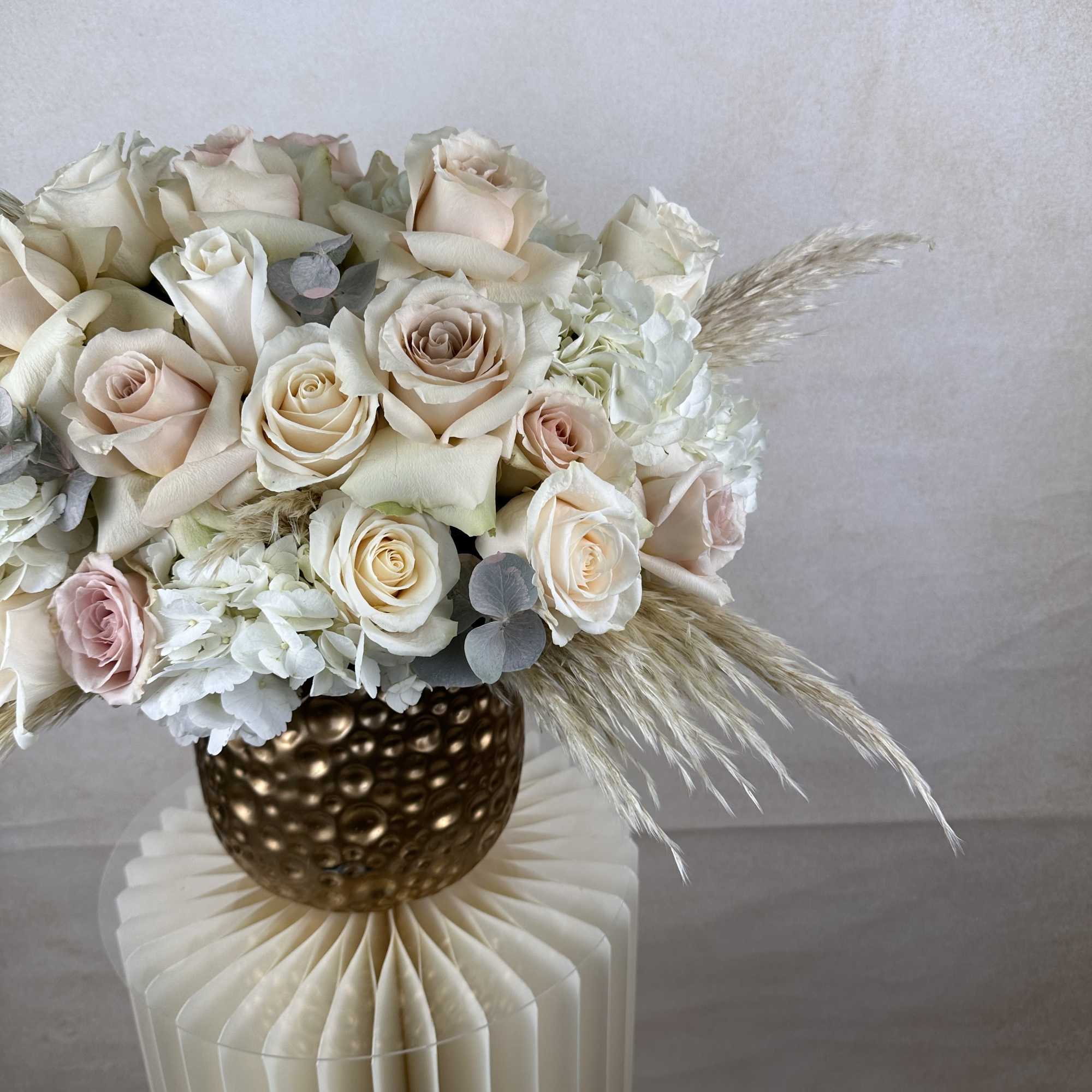 This stunning vase arrangement features a lush combination of elegant roses and