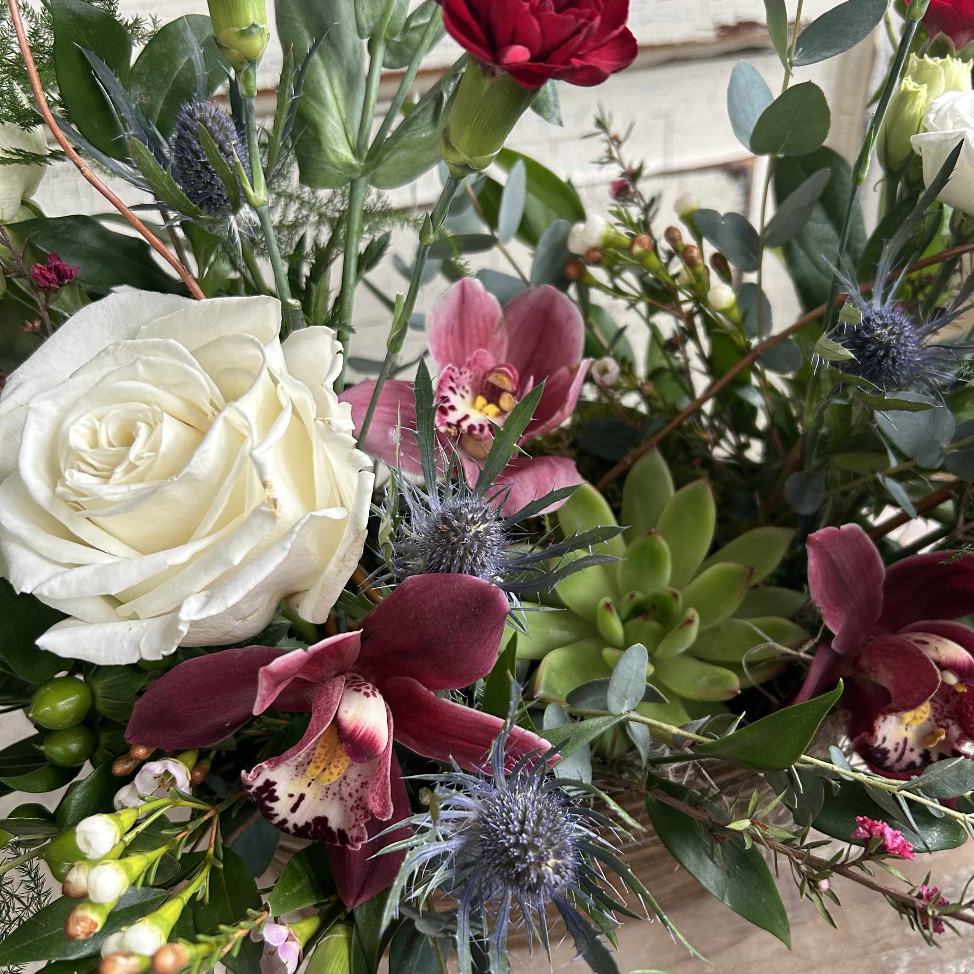 A metal tin or birch bark container is designed with an assortment