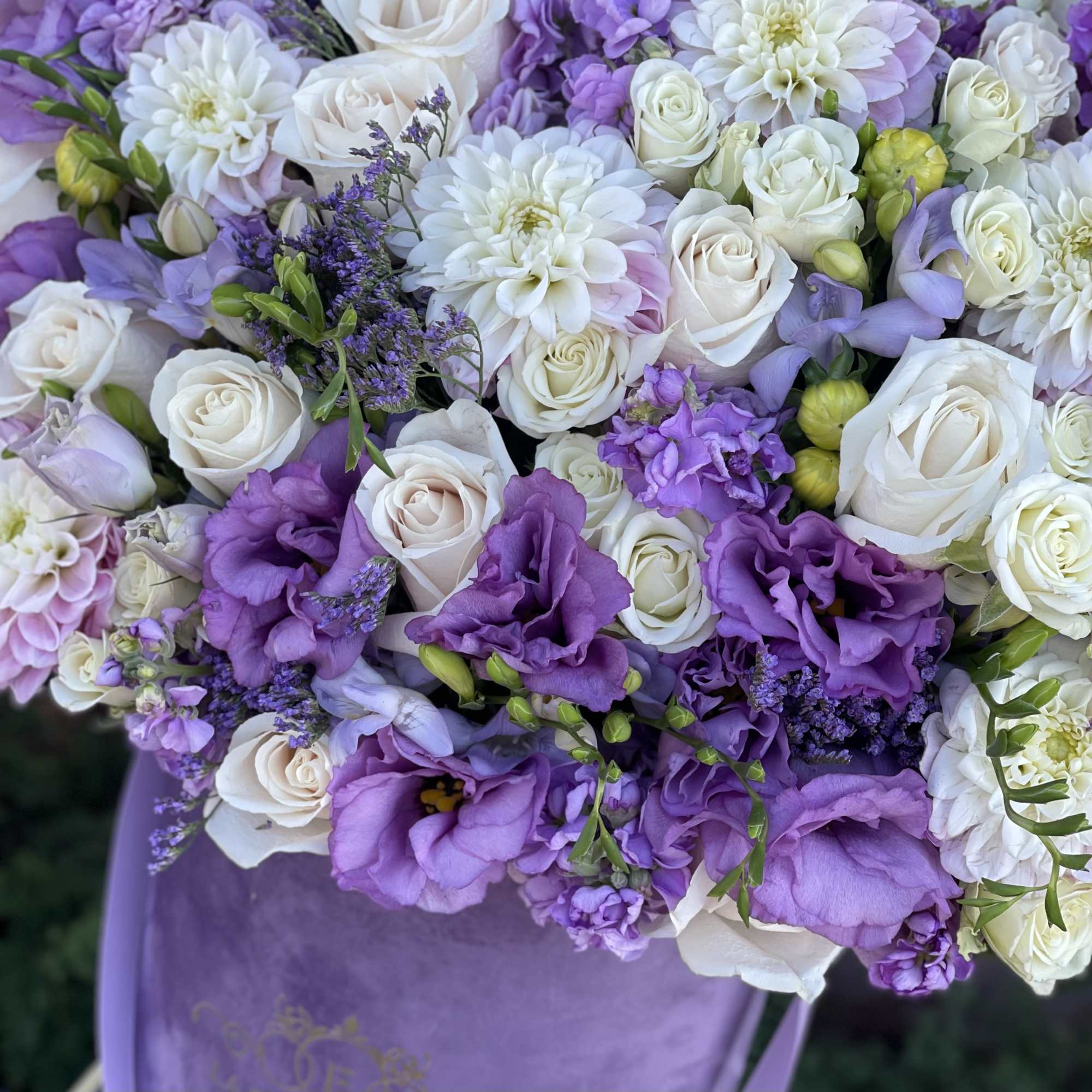 Beautiful arrangement of fresh flowers in our signature lavender velvet box 