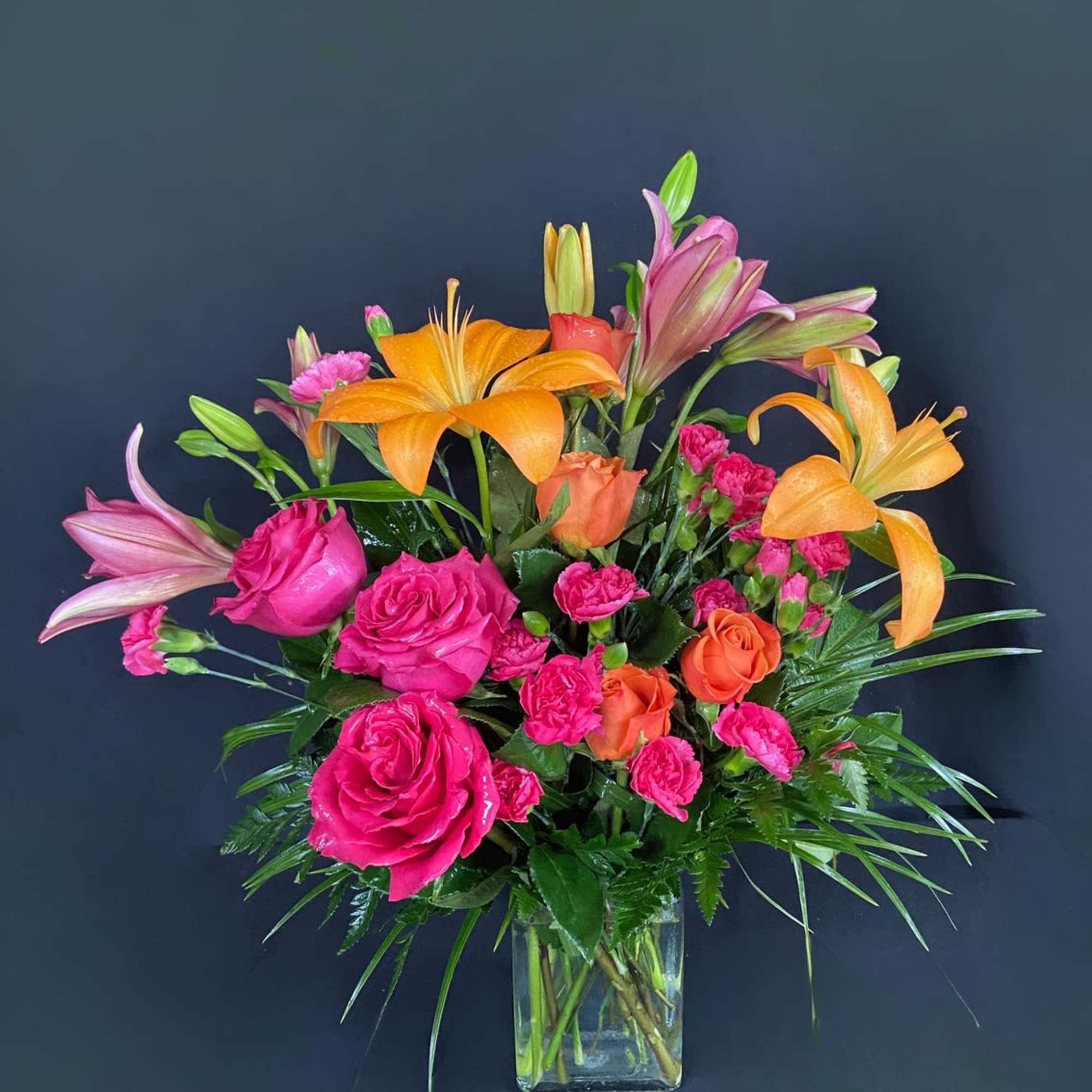This arrangement is electric! Send this bright orange and hot pink rose