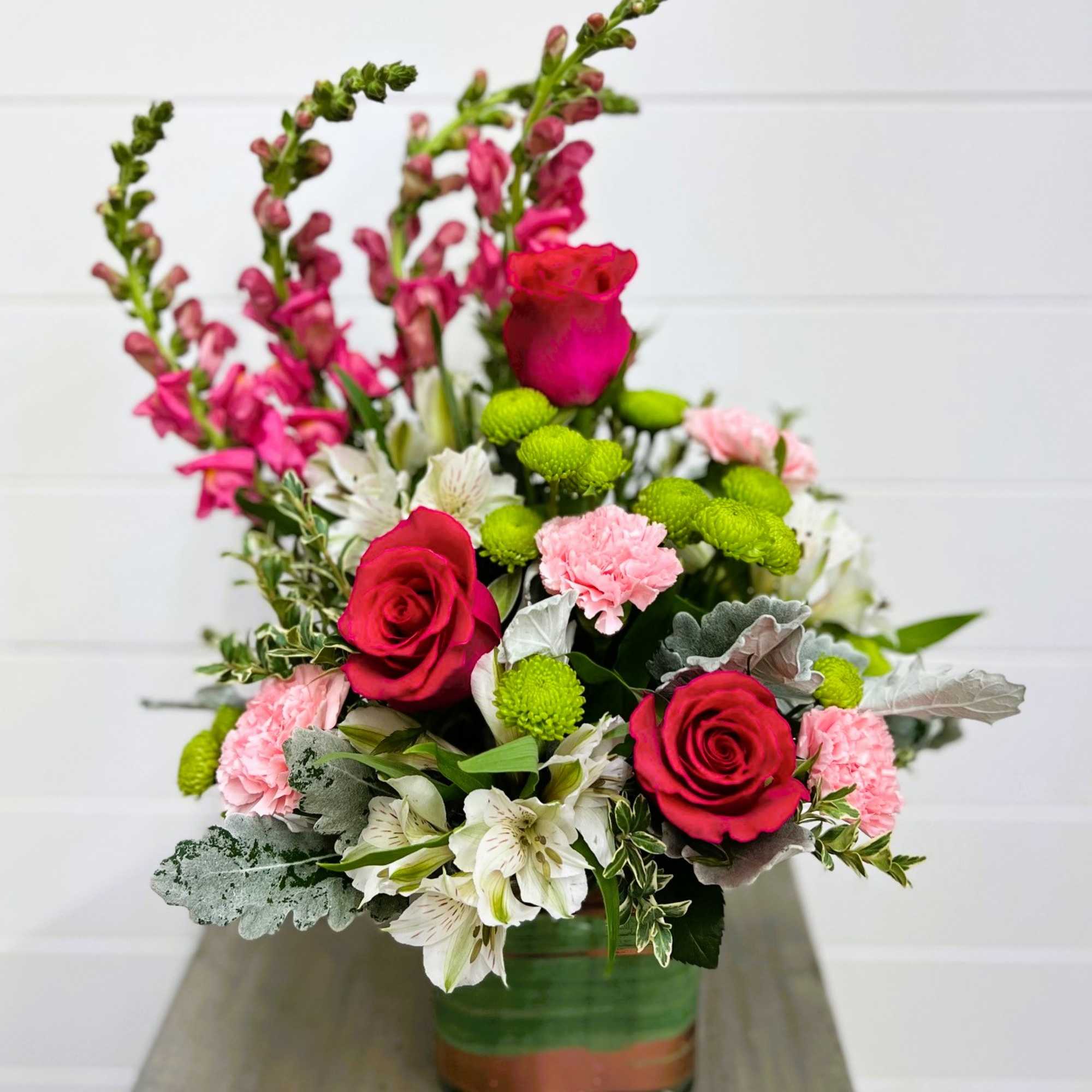 Fun and feminine this pink arrangement is reminiscent of a spring garden