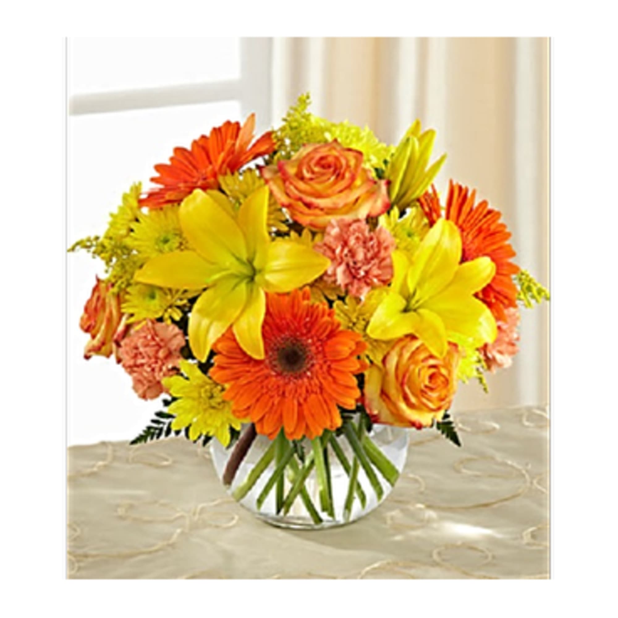 Stunning yellow Asiatic lilies, chrysanthemums and solidago are brought together with orange