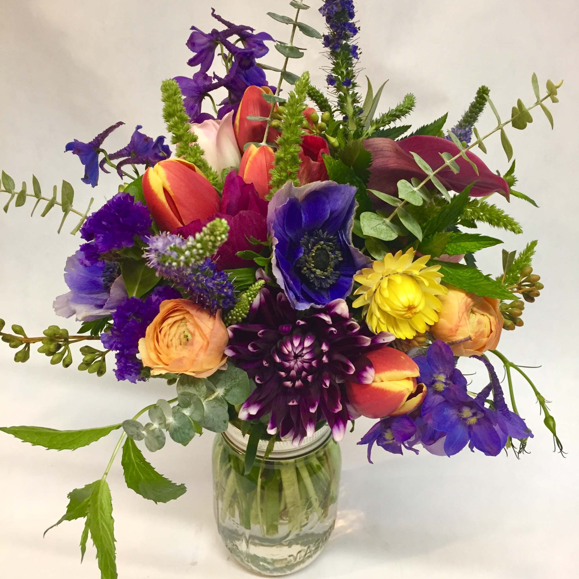 Bold, elegant, and full of personality, this unique jewel-toned arrangement is a