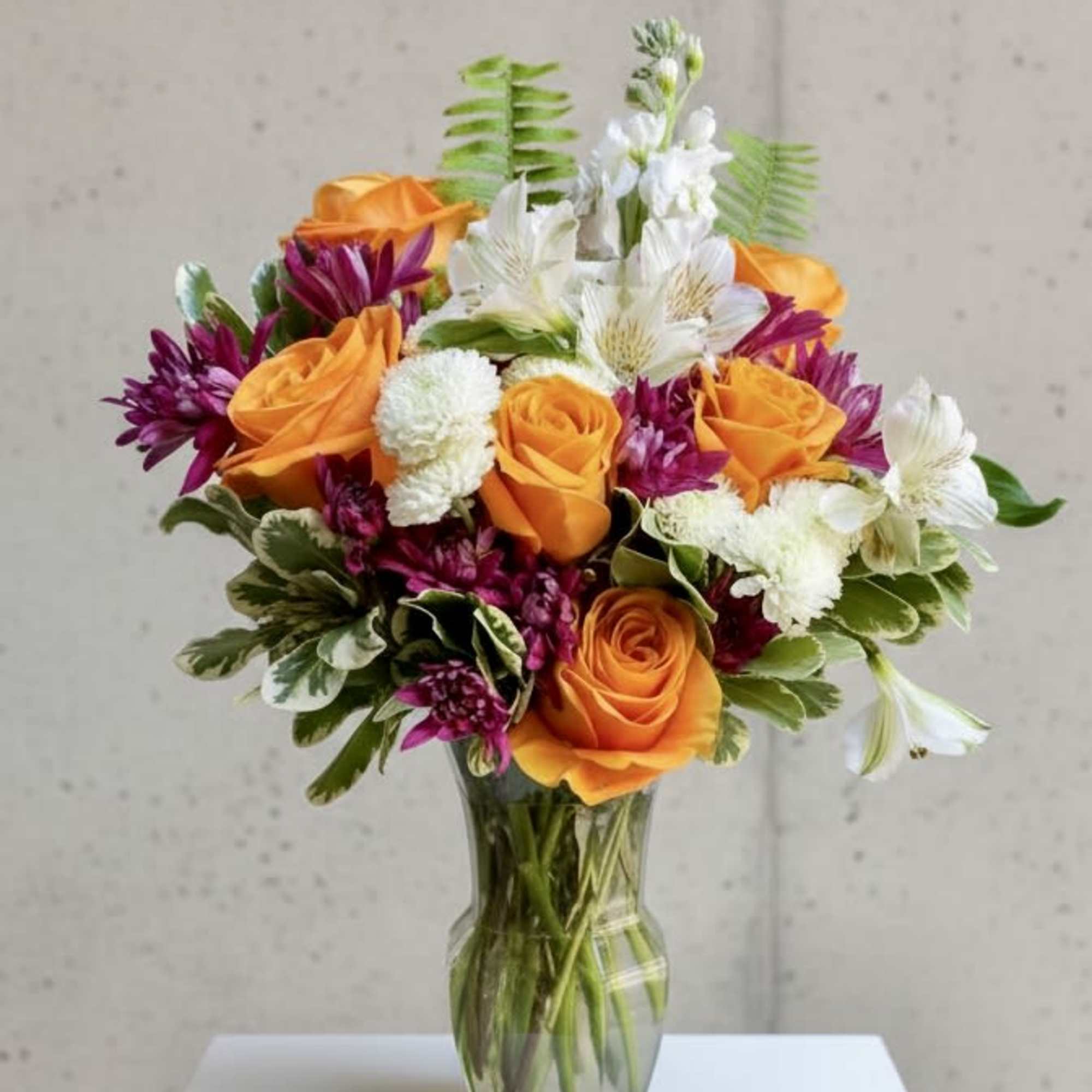 Perfect blend of roses and complimentary florals and greenery artistically put together