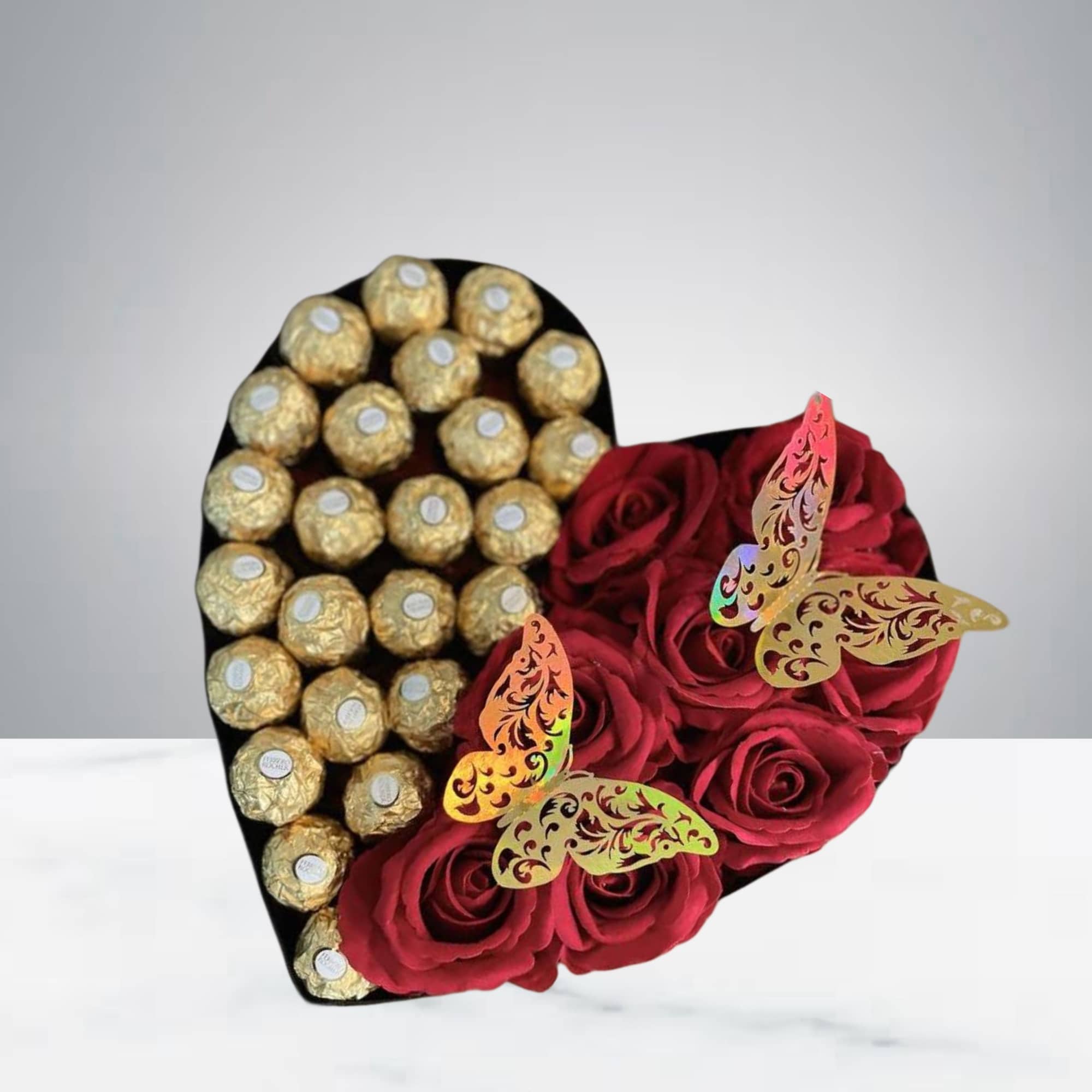 This beautiful arrangement of roses and chocolates comes in a heart-shaped box.