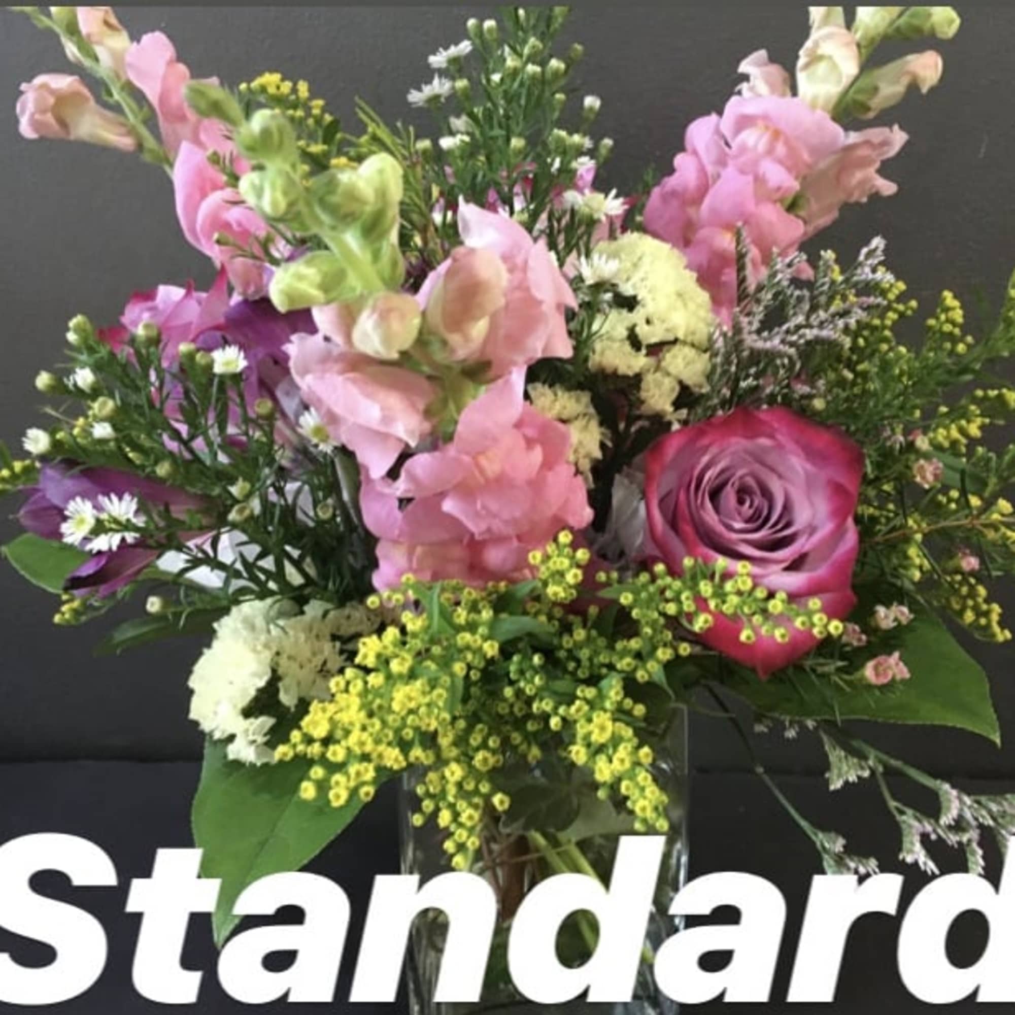 Beautiful snapdragons, roses and hydrangeas will be arranged with complementary additional flowers.