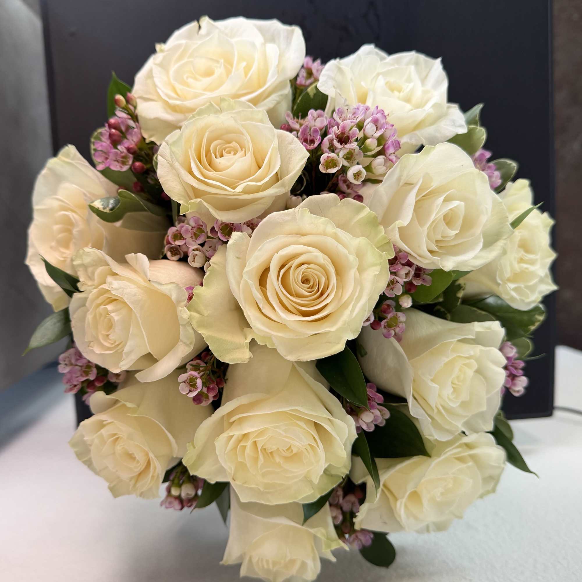 12 premium white roses in a low and lush style