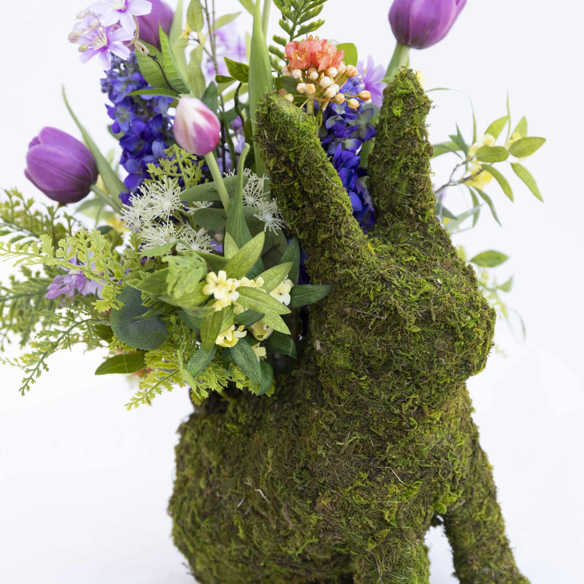 This adorable moss covered bunny is filled with artificial spring flowers. You