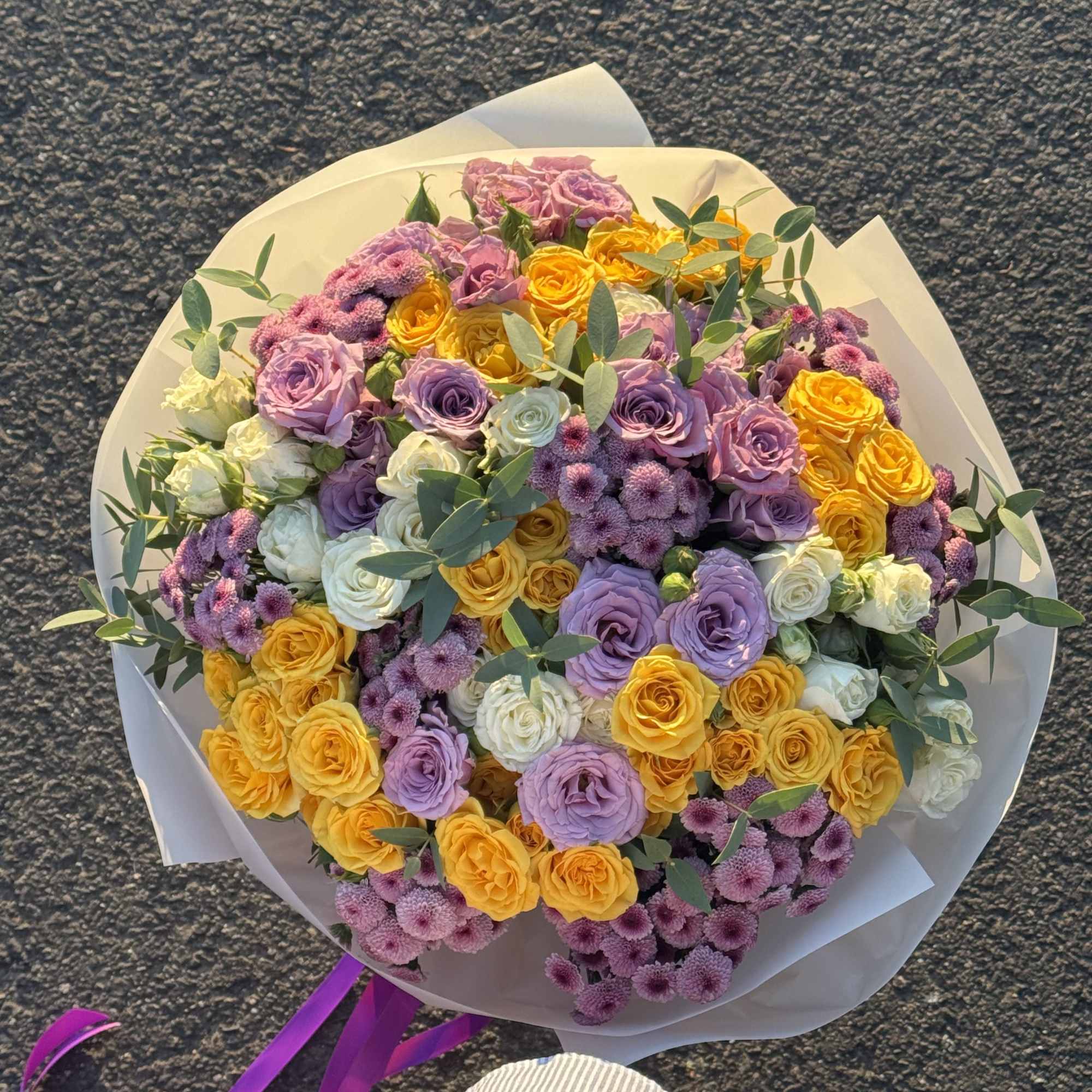 Bouquet with purple and yellow bush roses 
