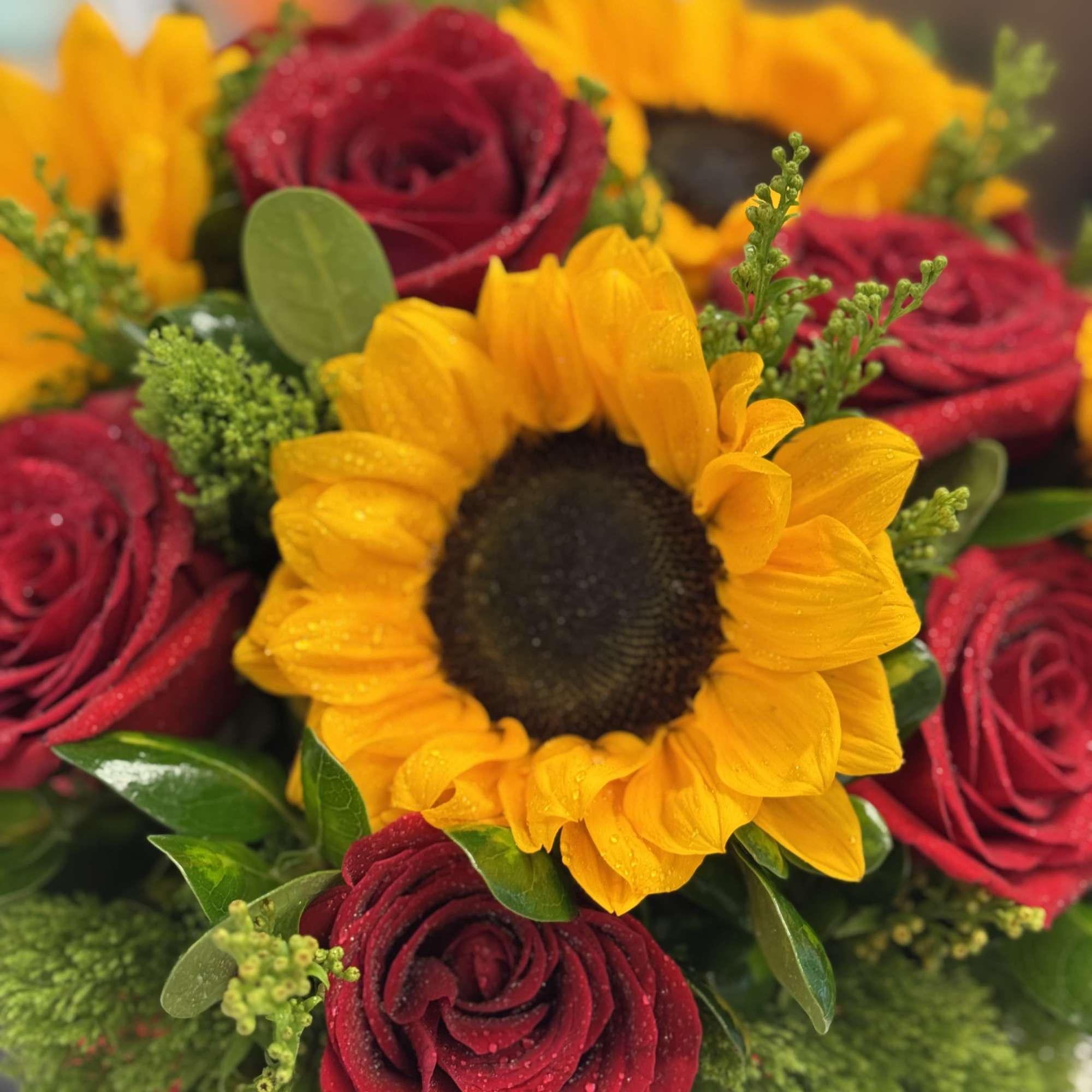 Bouquet of red roses and yellow sunflowers