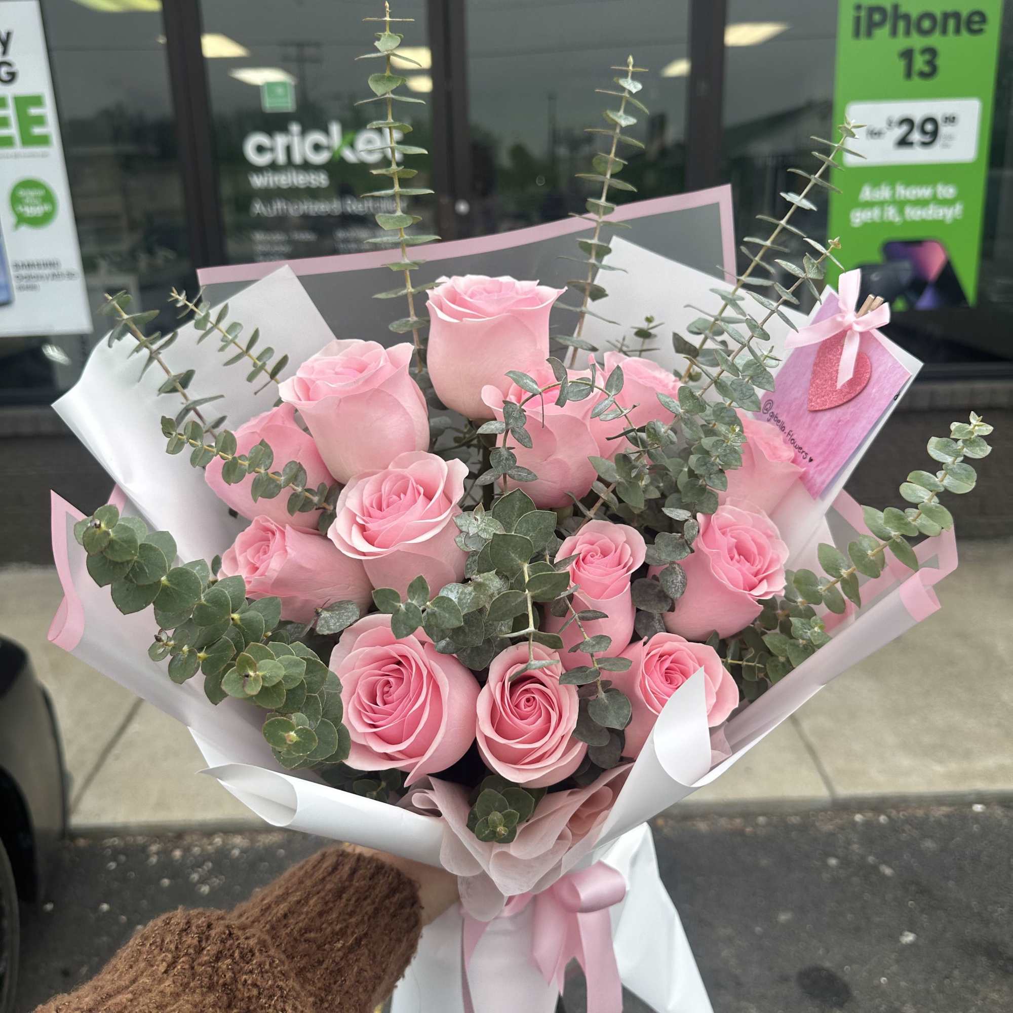 Bouquet of pink roses with eucalyptus in white and pink wrap