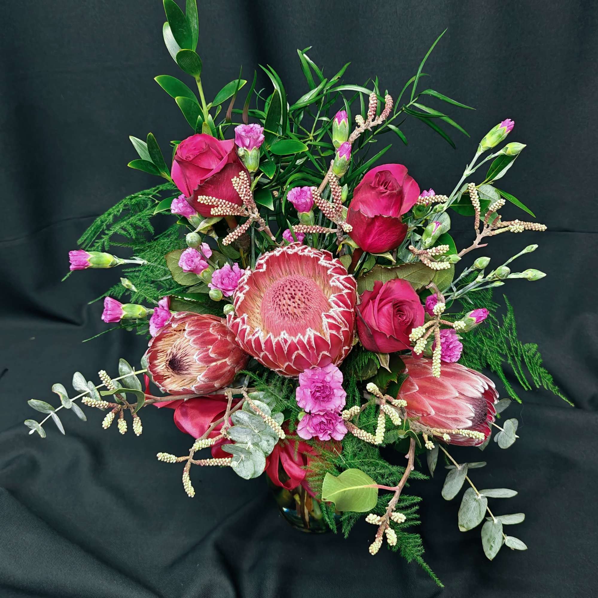 A medium size exotic bouquet.  Big beautiful African protea (exact variety