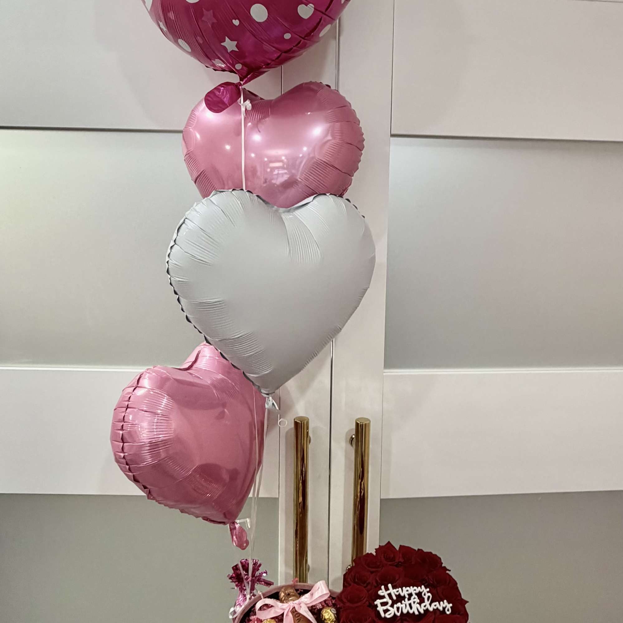 Birthday balloon bouquet with a heart-shaped rose box and champagne