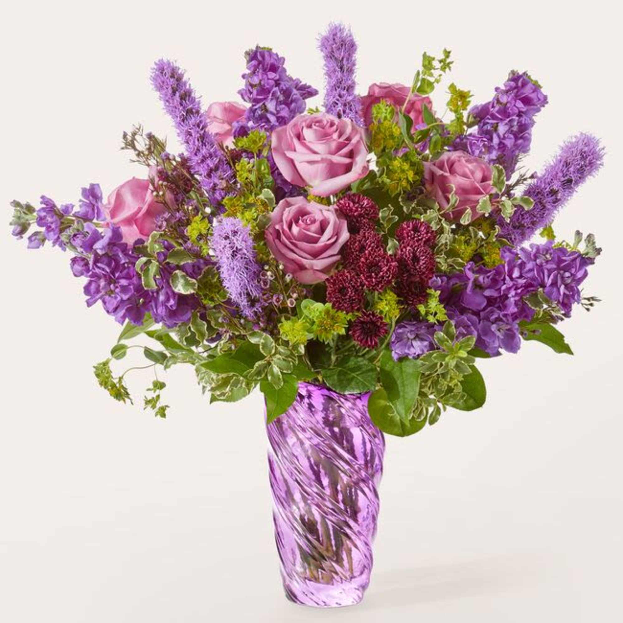 This arrangement exudes richness and artistic flair, anchored by a decorative purple