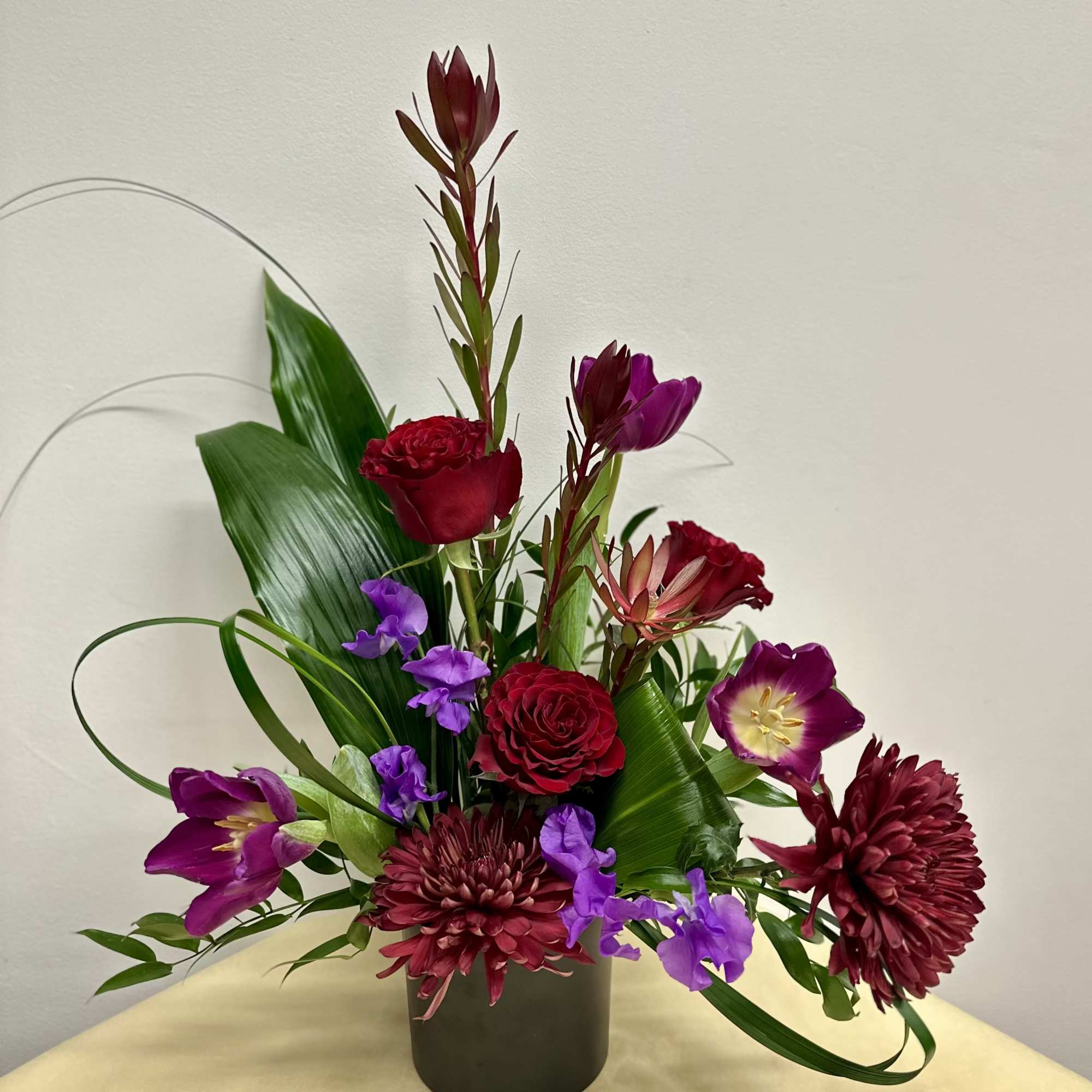  A captivating arrangement that embraces deep, moody elegance with a bit