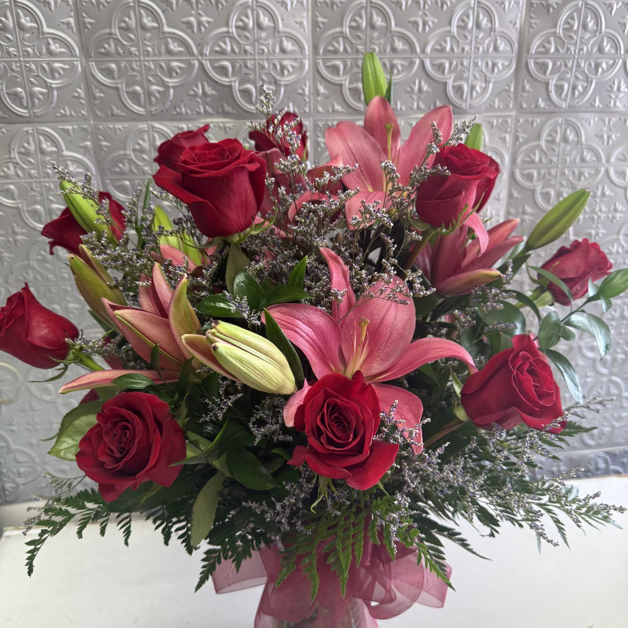 Beautiful red roses with pink lilies for a romantic occasion and impress