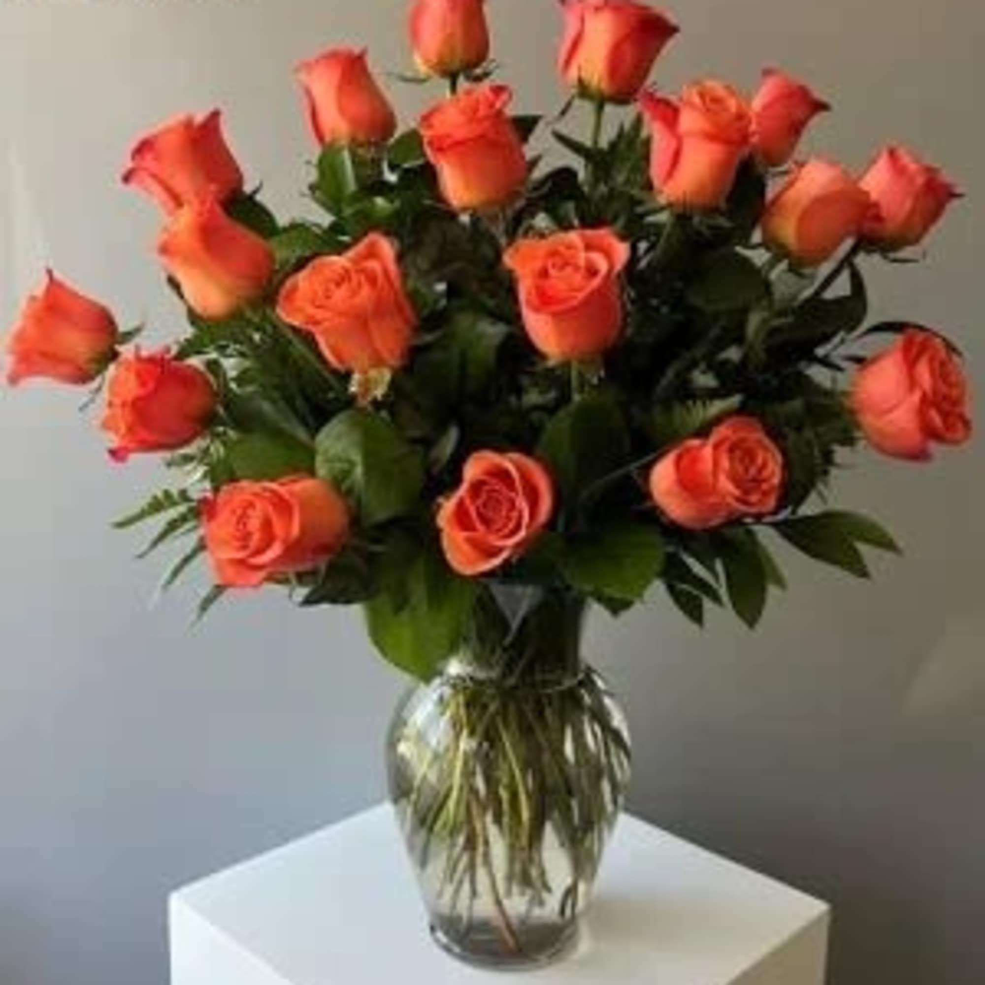 12 Orange Roses arranged in a vase