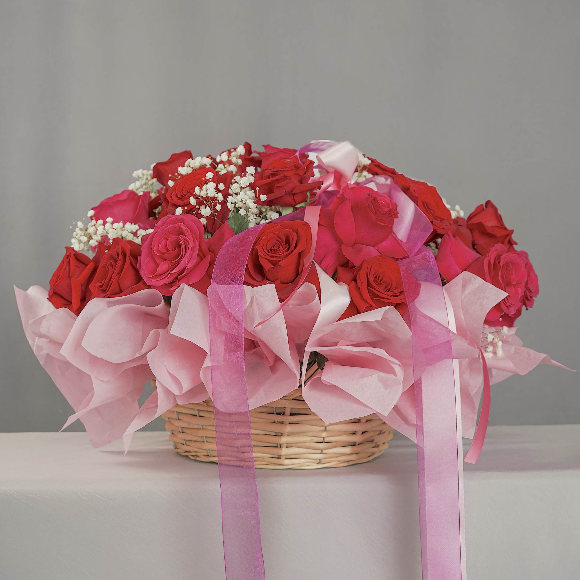 Elegant basket arrangement featuring 32 premium red and hot pink roses 
