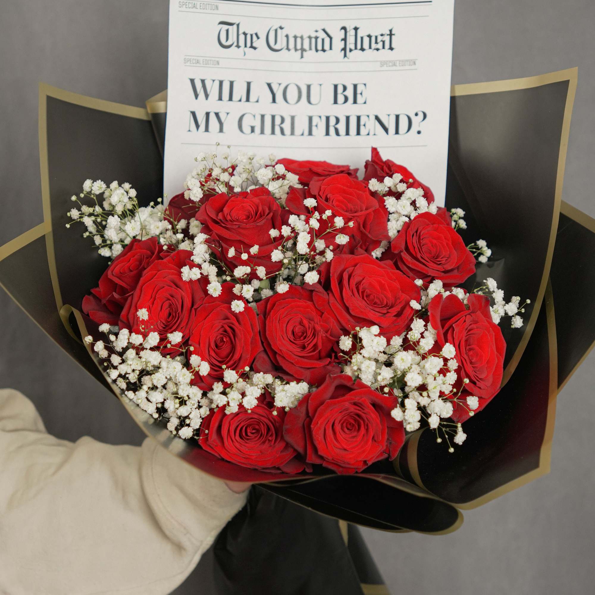 Striking bouquet featuring 12 premium red roses, imported from Ecuador, wrapped in