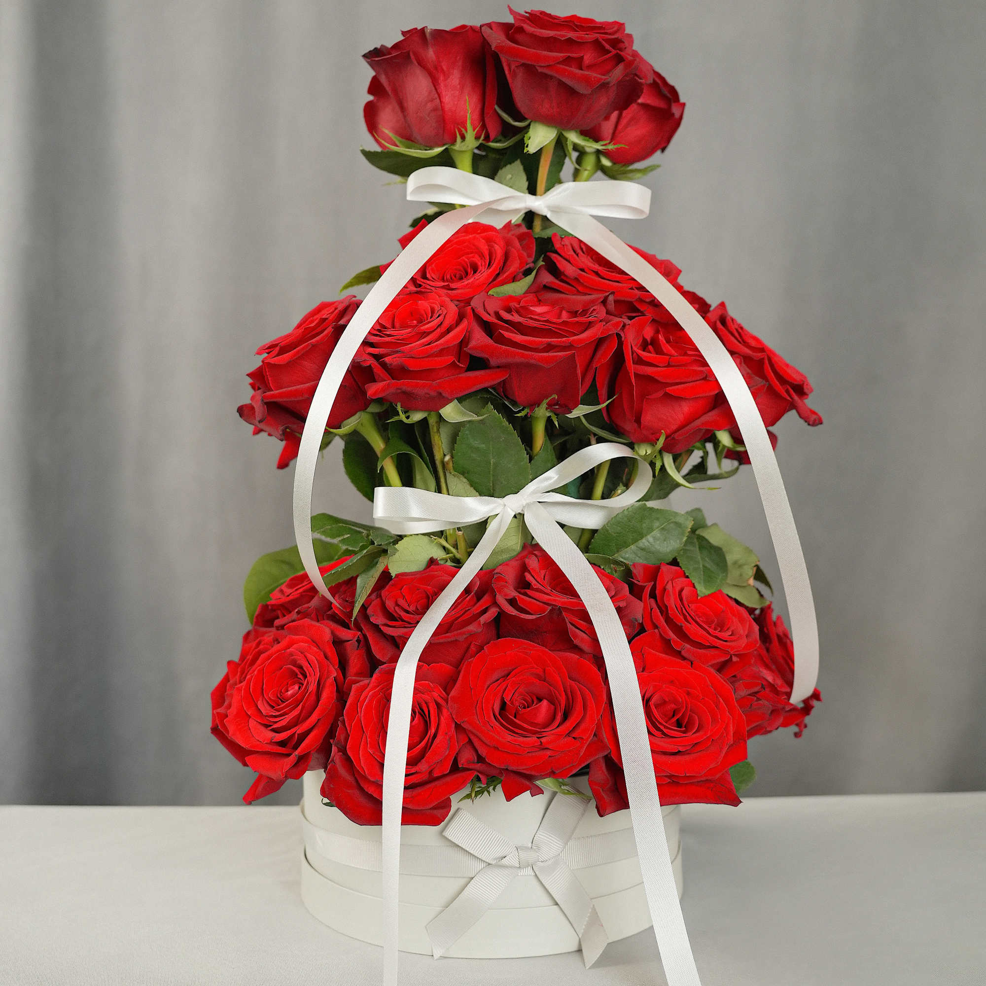 This stunning tower arrangement features 48 premium 50 cm roses, imported directly