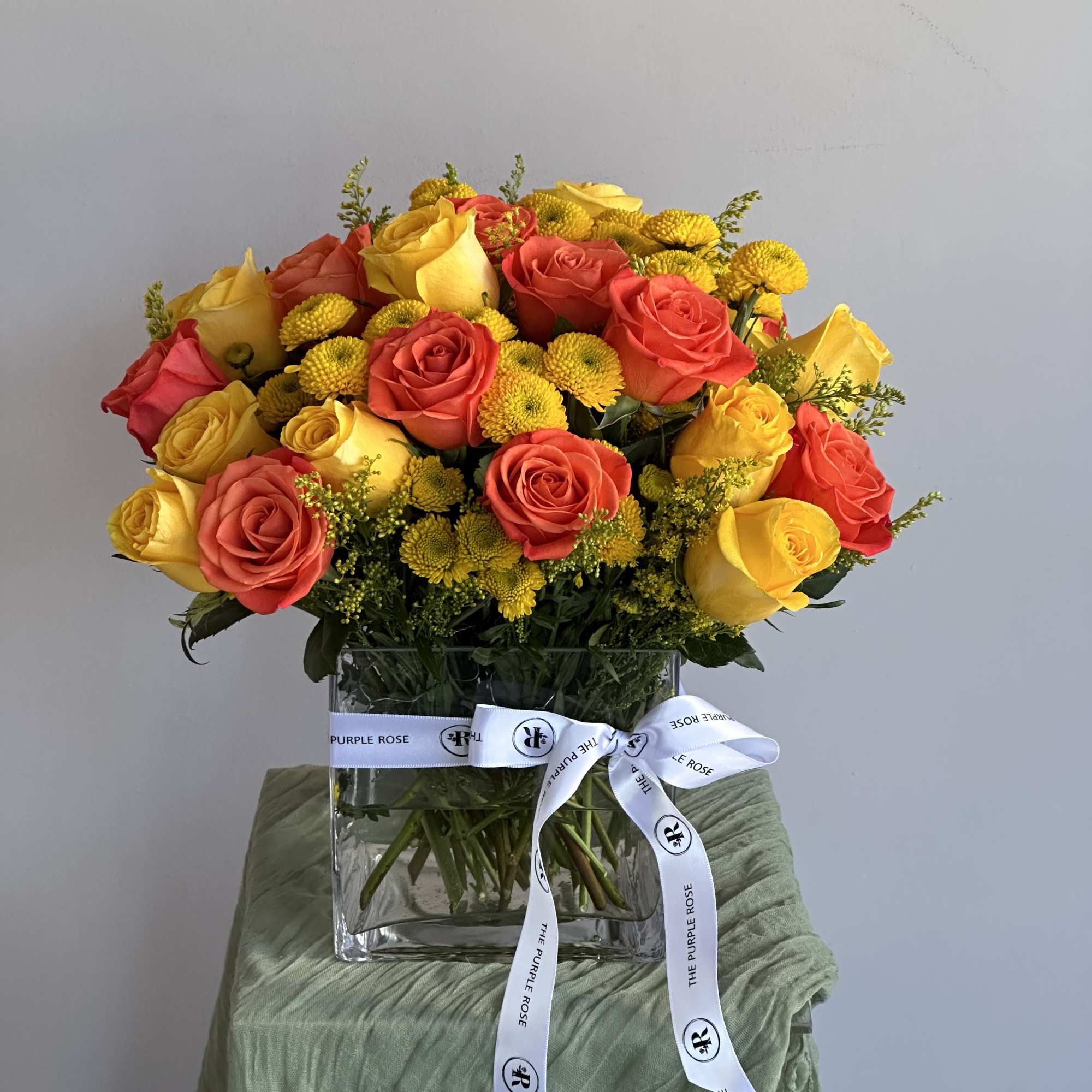 Yellow and orange roses come together for a fun and fresh arrangement.