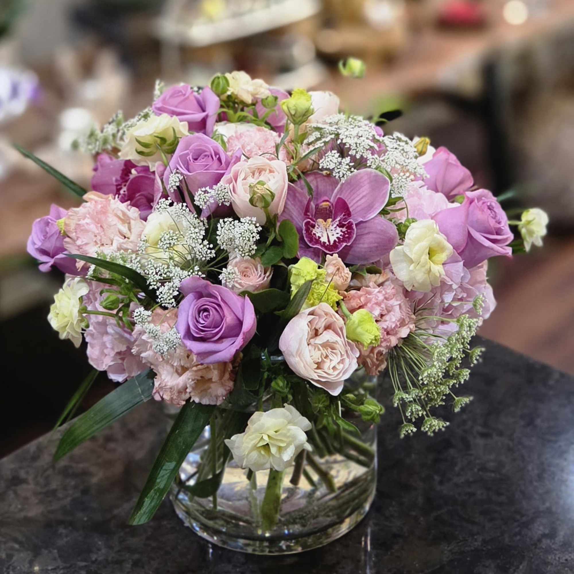 This design is in a large glass cylinder vase, and is 16-18"