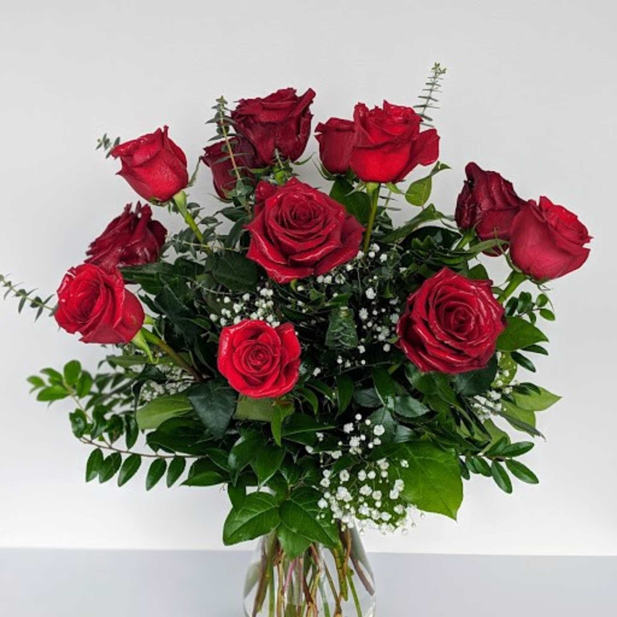 A beautiful arrangement of a dozen long-stemmed roses in your choice of