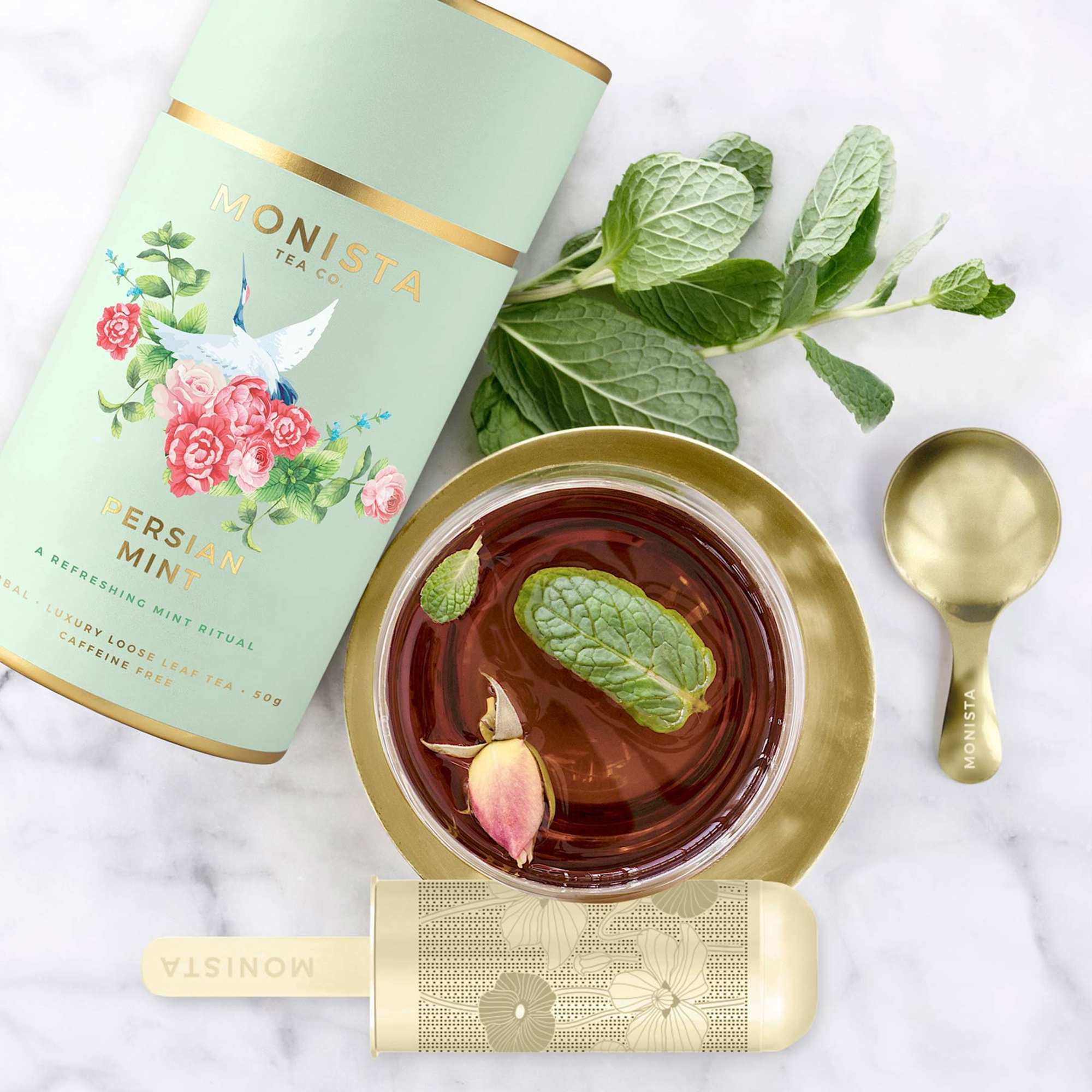 A refreshing mint ritual. Handwoven Persian rugs cover the earthen tiles, the