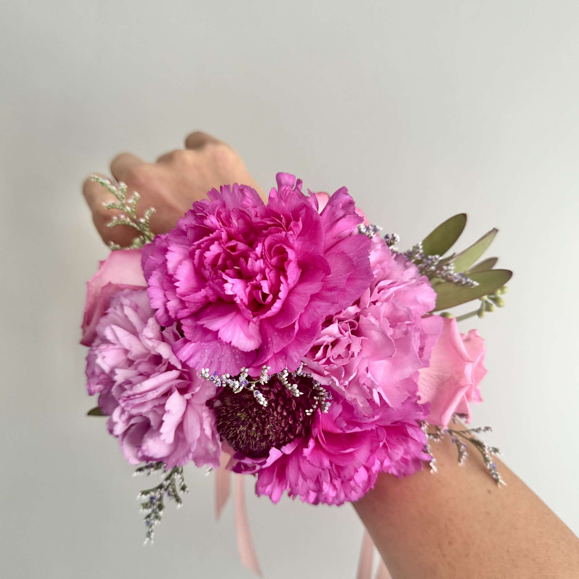 Pink and lavender hand-tied bouquet with carnations and roses