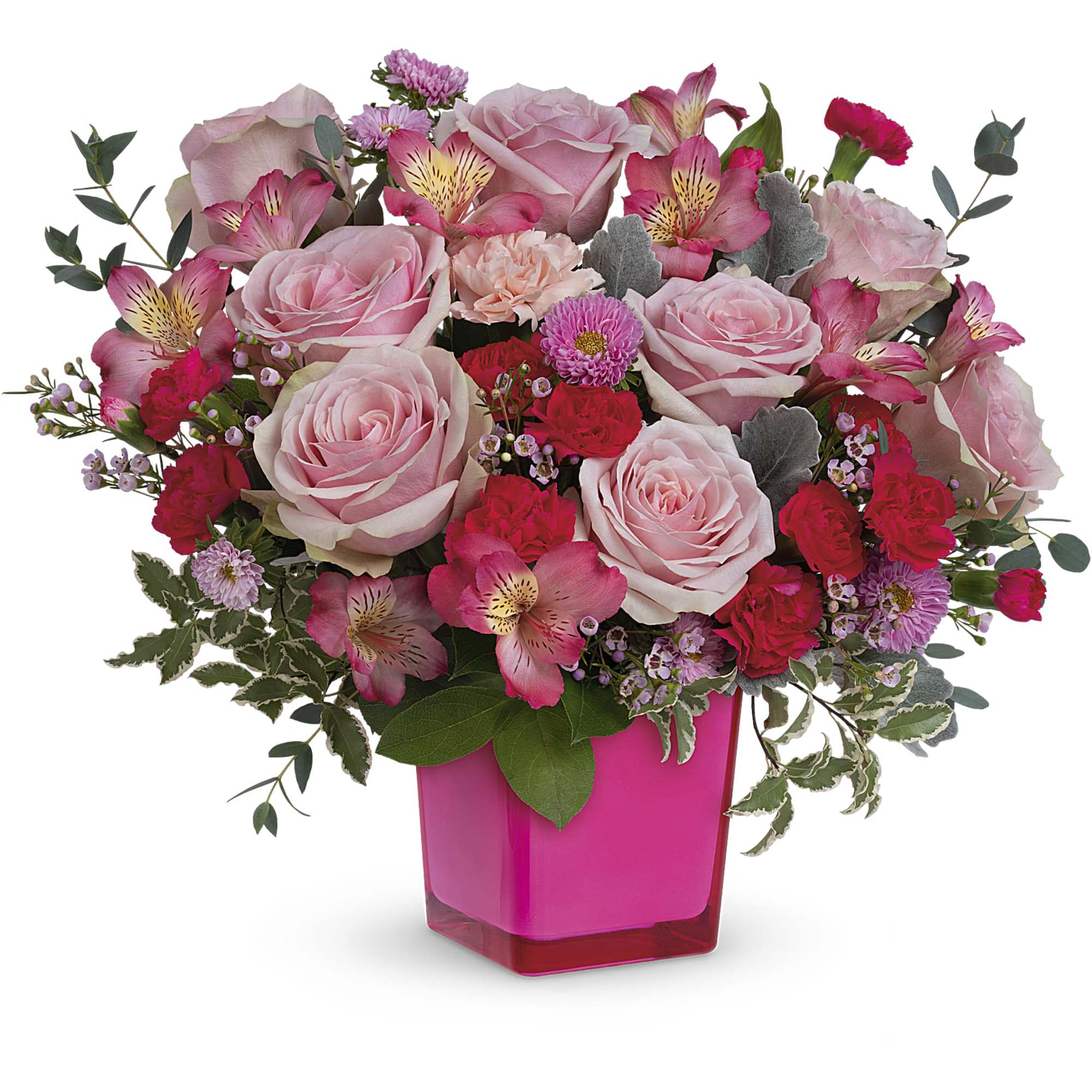 Pink roses and mixed flowers arranged in a bright pink vase