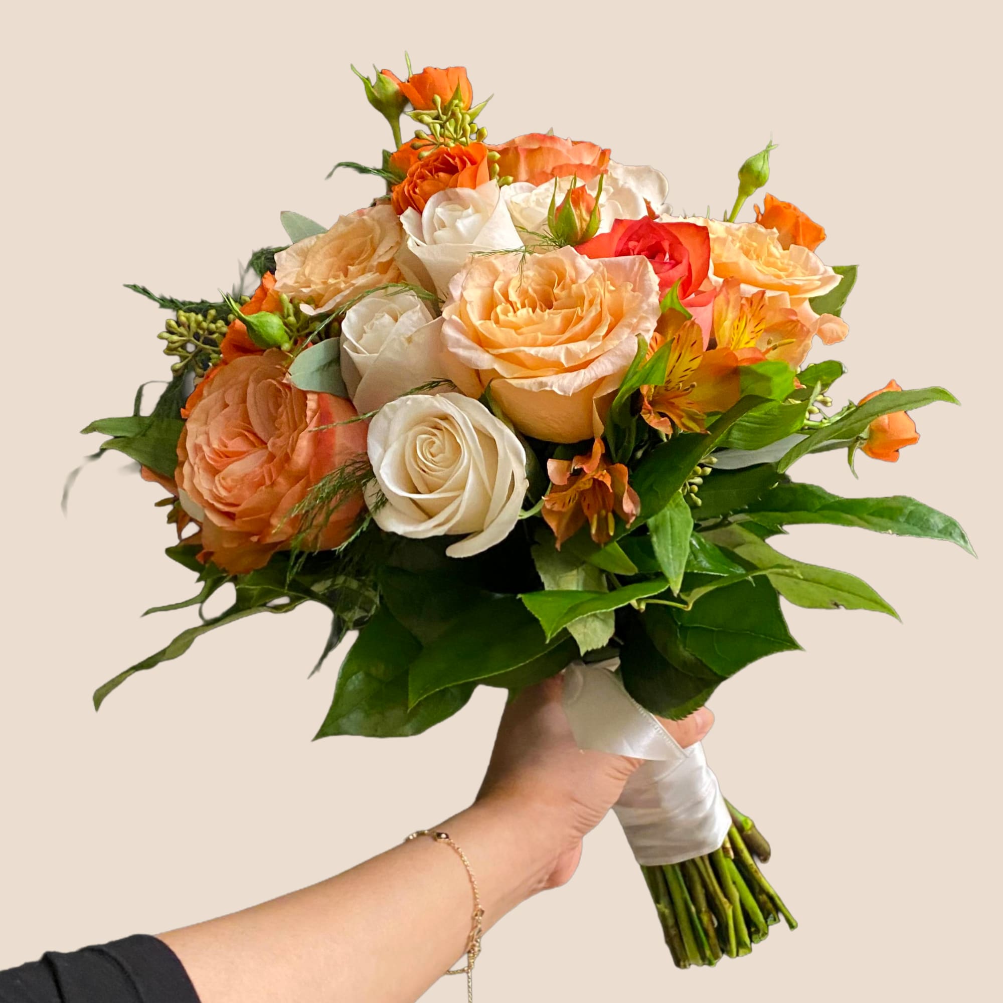 Warm, radiant, and beautifully romantic, the Golden Peach Garden bouquet celebrates soft