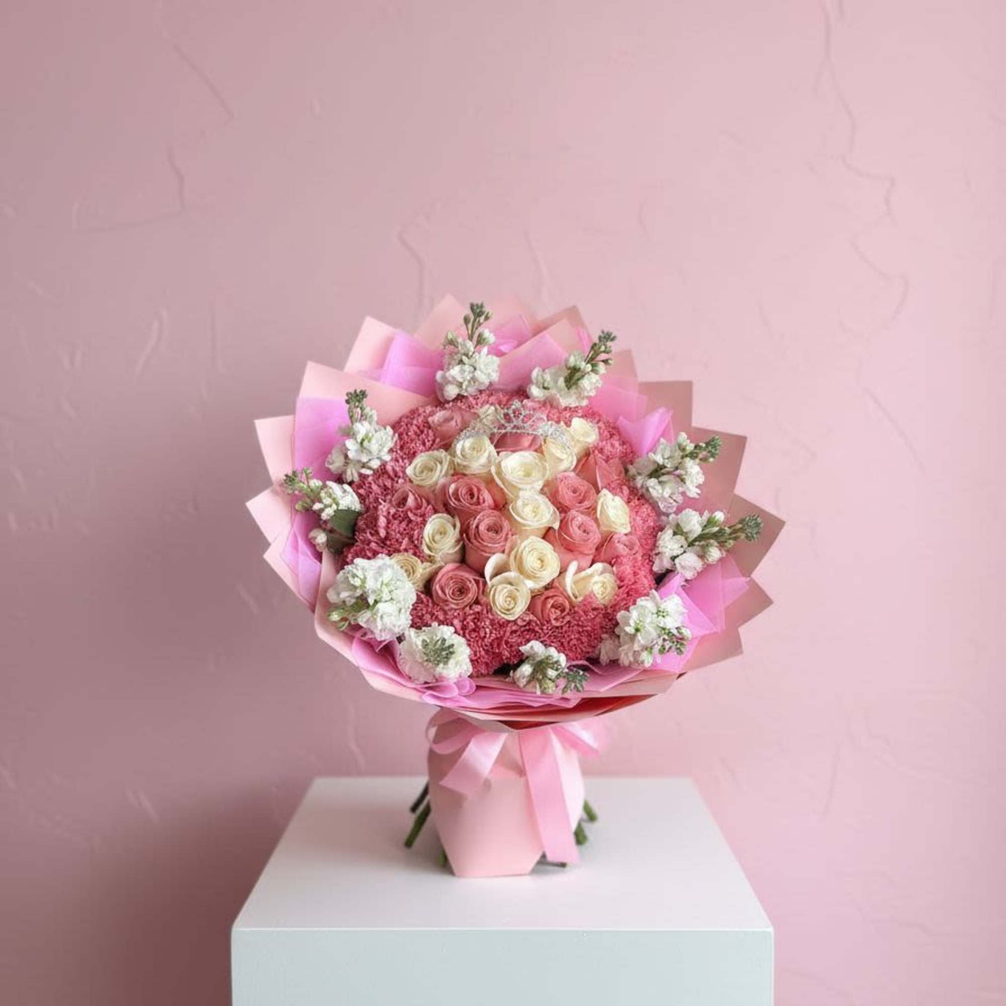 Pink and cream rose bouquet wrapped in pink paper