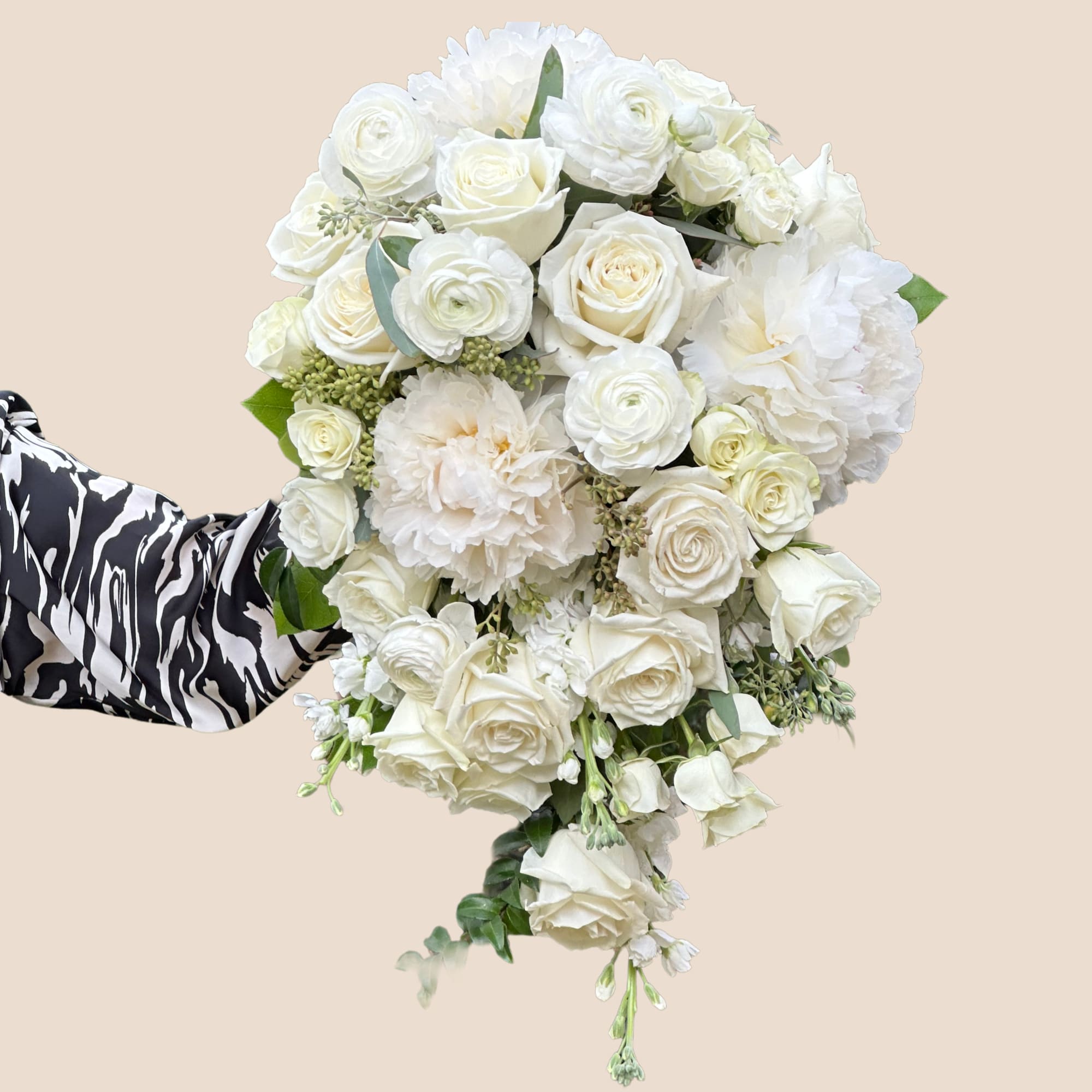 Romantic, luxurious, and gracefully dramatic &mdash; this all-white cascading bouquet is designed