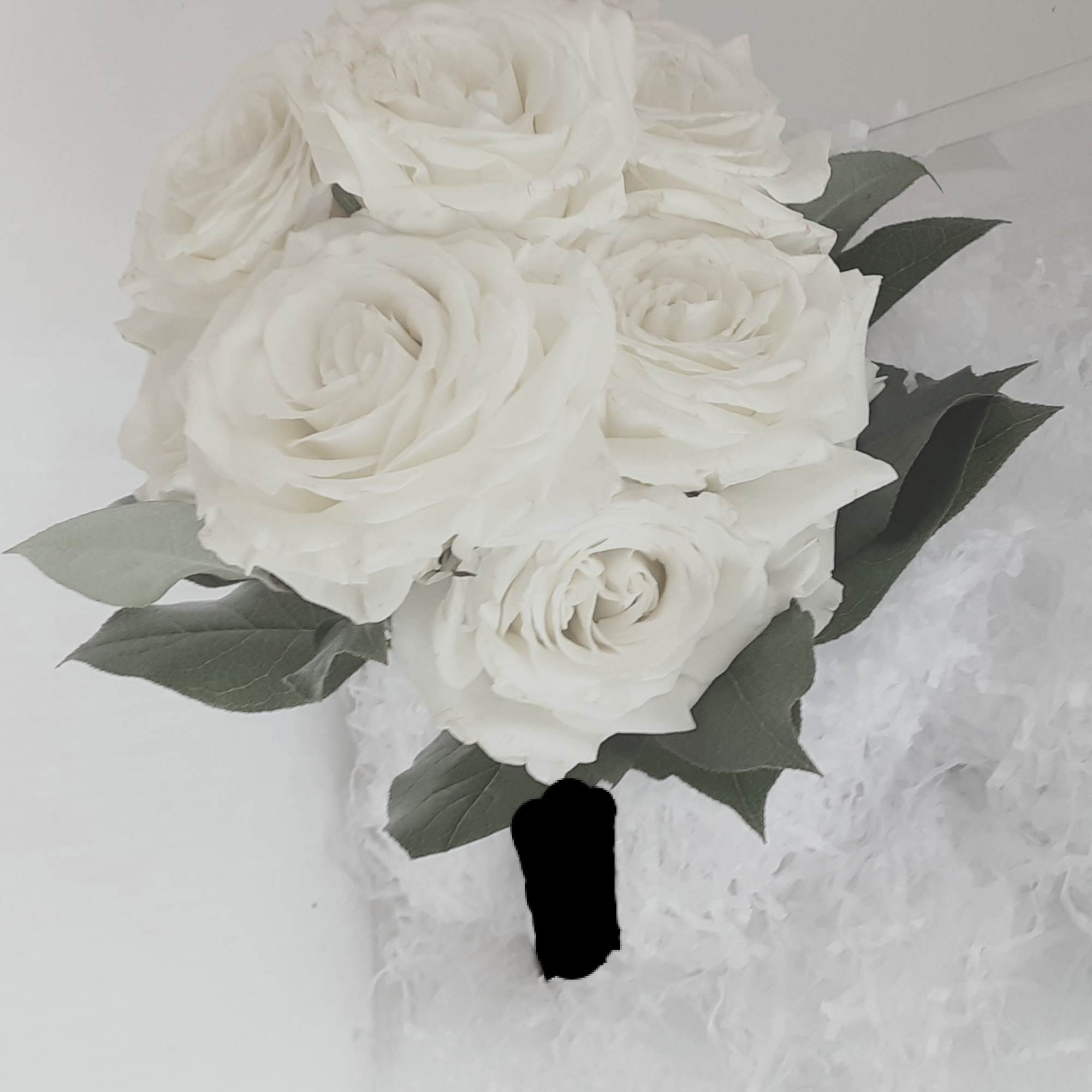 A classic rose and baby's breath bouquet hand tied with ribbon. The