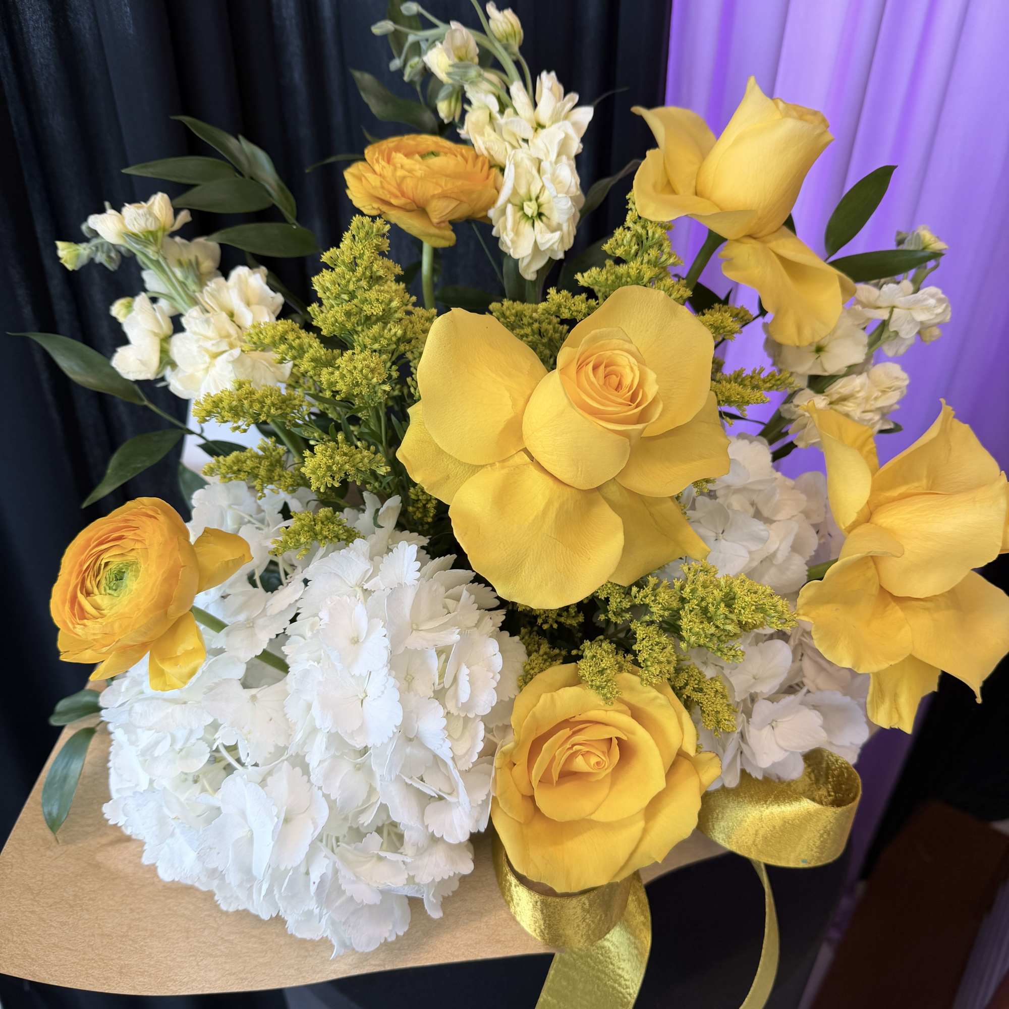 This arrangement has a bright, elegant yellow and white look with a
