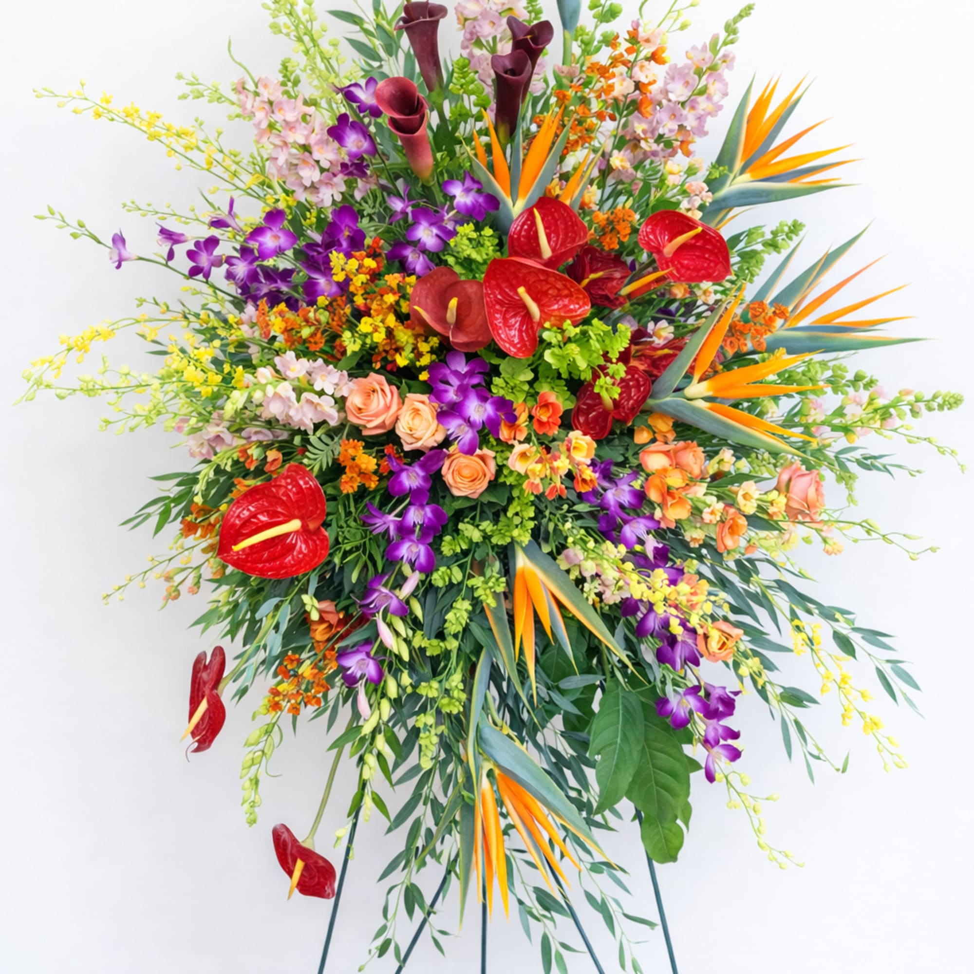 A vibrant tropical standing spray with exotic blooms and lush greenery, perfect
