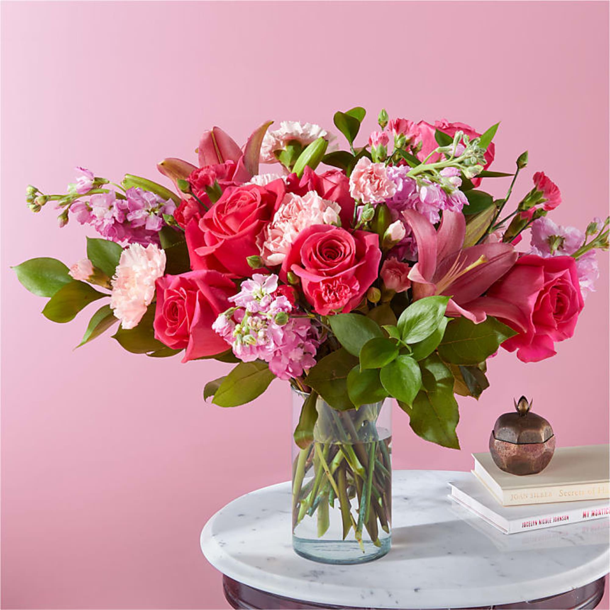 Carnations, roses, or lilies arrive fresh in the full spectrum of pink